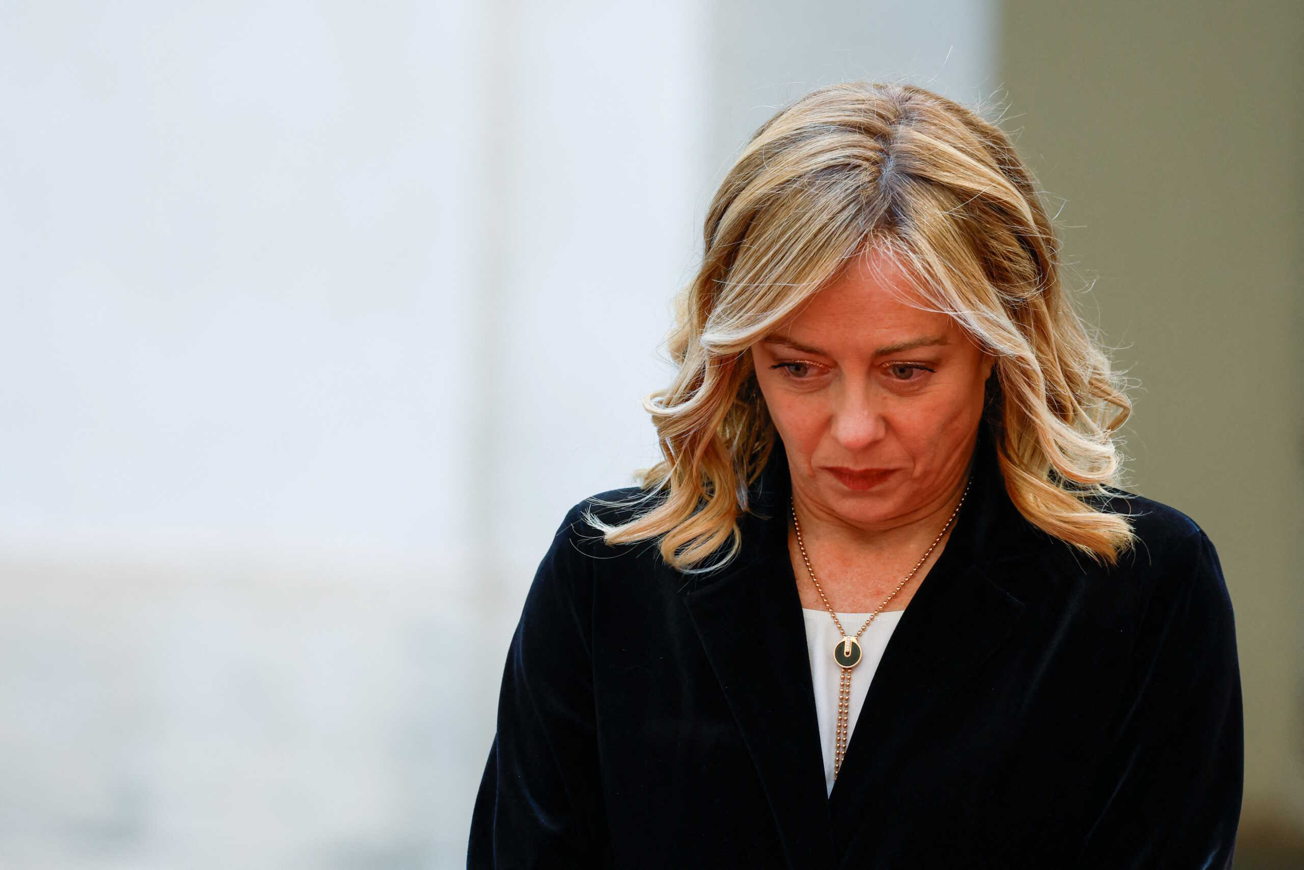 Italian Prime Minister Giorgia Meloni looks down, on the day she meets with British Prime Minister Rishi Sunak (not pictured) at Palazzo Chigi, in Rome, Italy, December 16, 2023. REUTERS