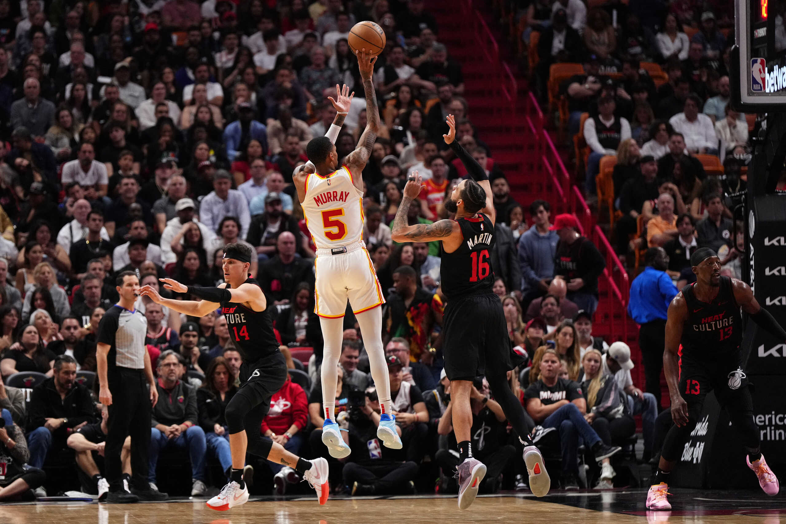 Jan 19, 2024; Miami, Florida, USA; Atlanta Hawks guard Dejounte Murray (5) shoots over Miami Heat forward Caleb Martin (16) during the first half at Kaseya Center. Mandatory Credit: Jasen Vinlove-USA TODAY Sports