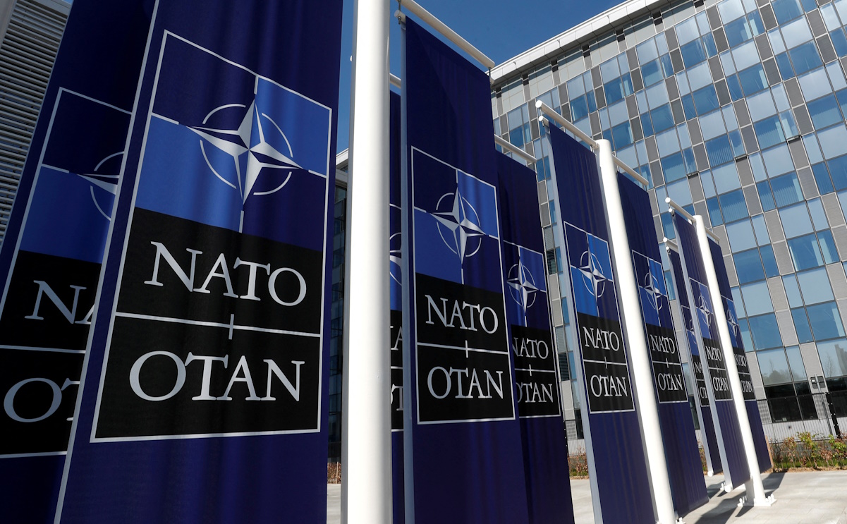 FILE PHOTO: Banners displaying the NATO logo are placed at the entrance of new NATO headquarters during the move to the new building, in Brussels, Belgium April 19, 2018.  REUTERS