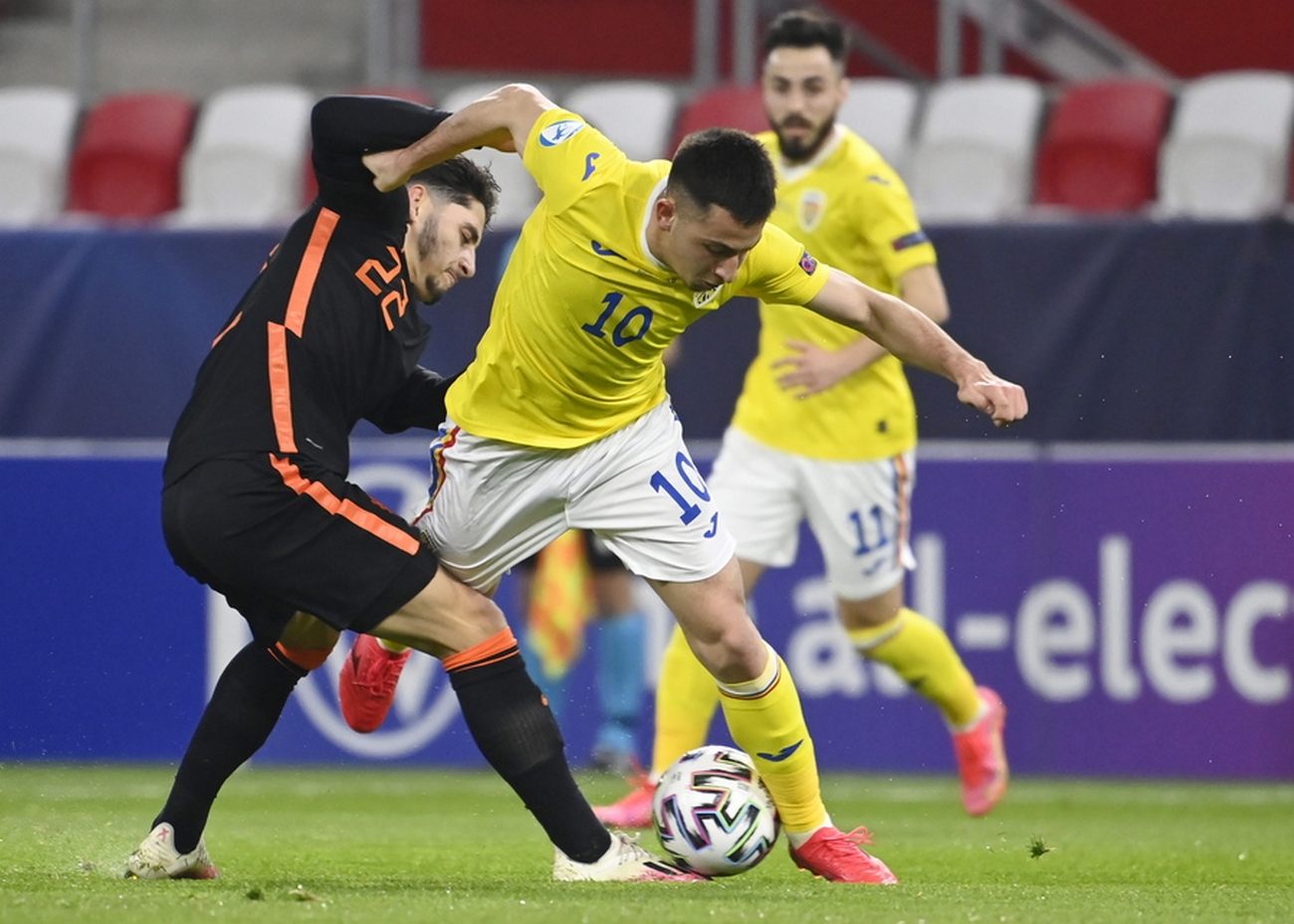 epa09094869 Olimpiu Morutan of Romania in action against Ludovit Reis (L) of the Netherlands during the UEFA U21 Championship match between Romania and the Netherlands, in Budapest, Hungary, 24 March 2021.  EPA