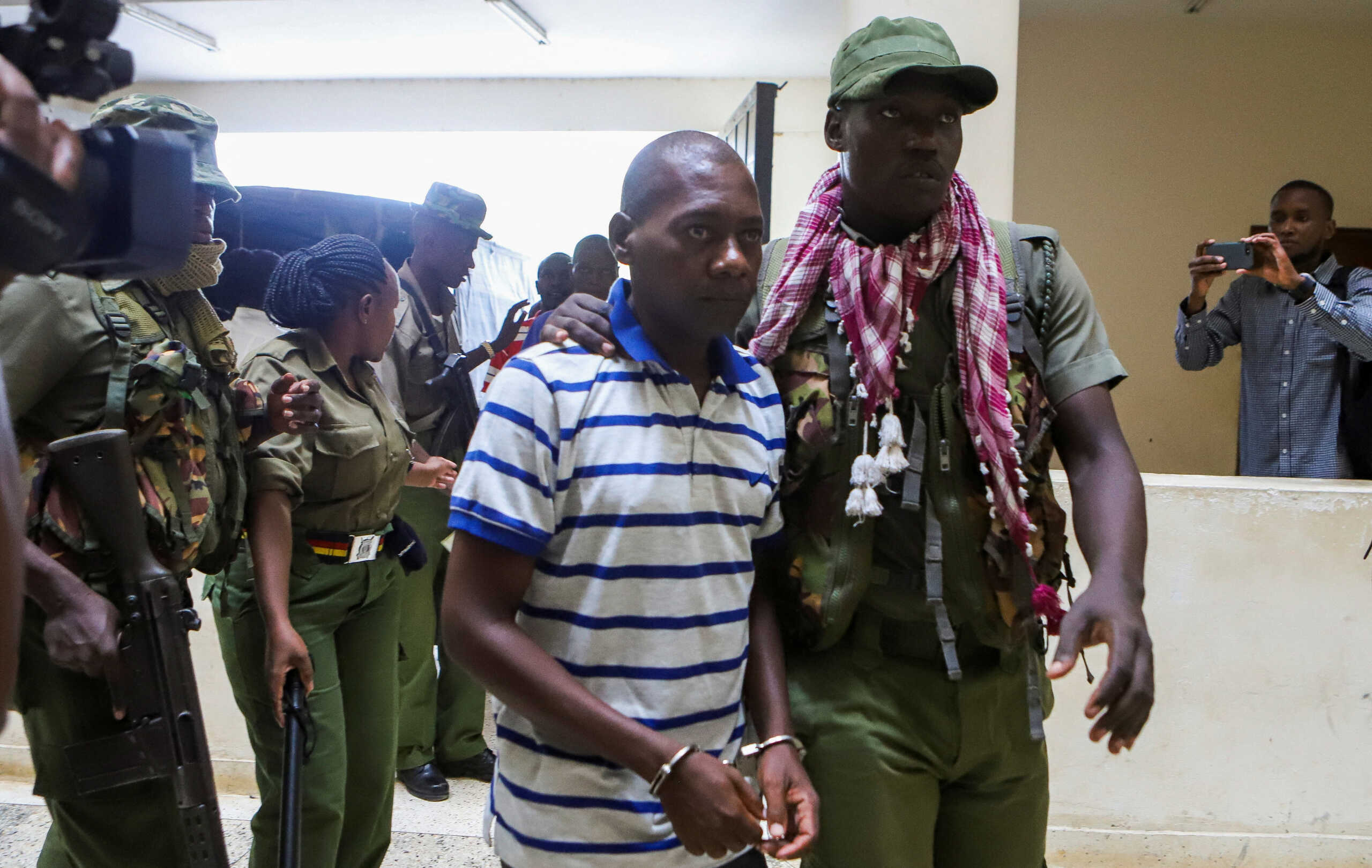 Paul Mackenzie, a Kenyan cult leader accused of ordering his followers, who were members of the Good News International Church, to starve themselves to death in Shakahola forest, is escorted to the Malindi Law Courts in Malindi, Kilifi, Kenya January 17, 2024. REUTERS