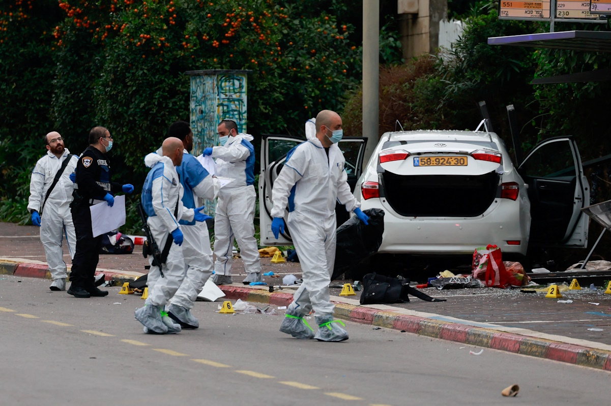 People work next to a vehicle following a suspected ramming attack in Raanana, Israel January 15, 2024. REUTERS