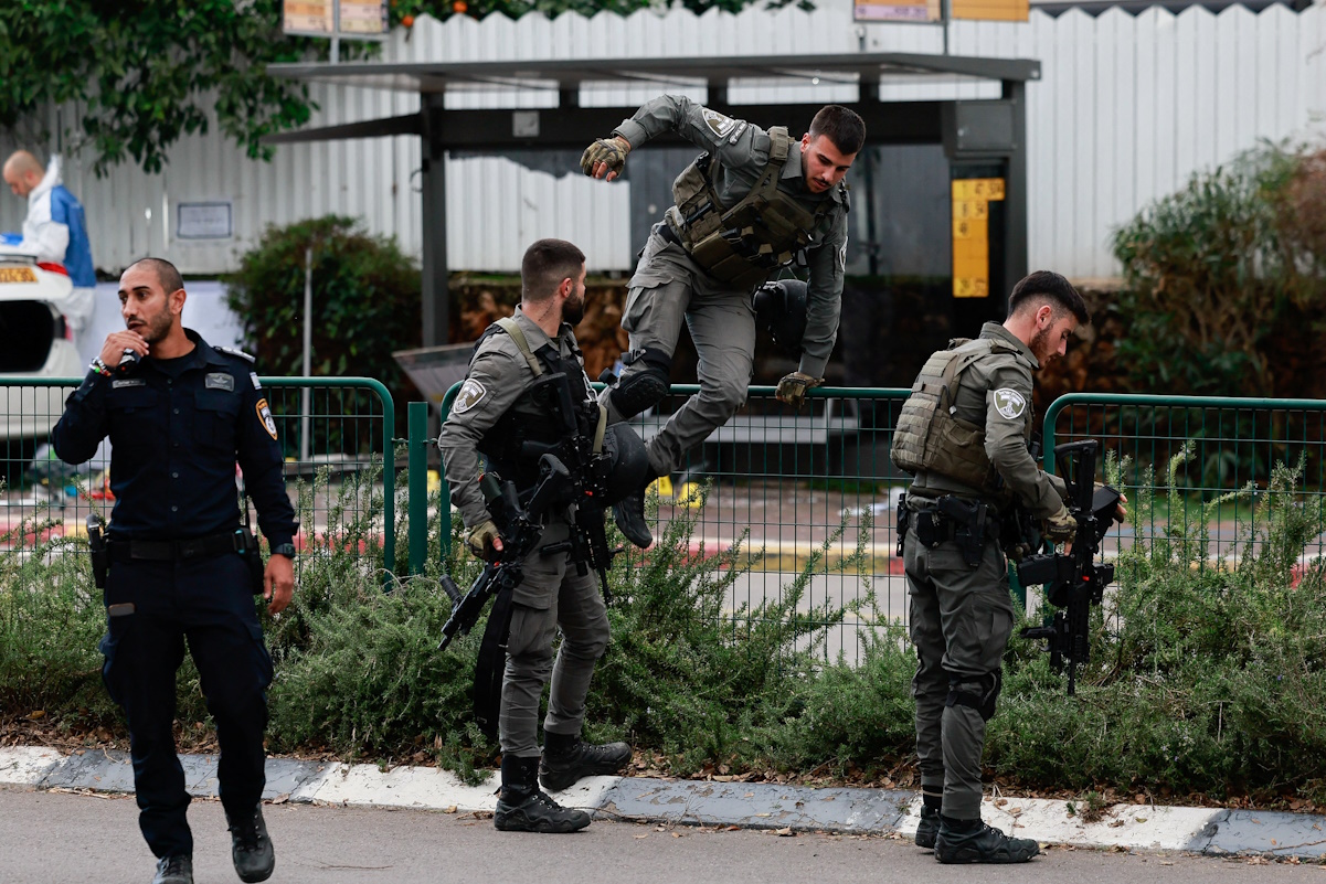 A member of the Israeli Border Police jumps at the site of a suspected ramming attack in Raanana, Israel January 15, 2024. REUTERS