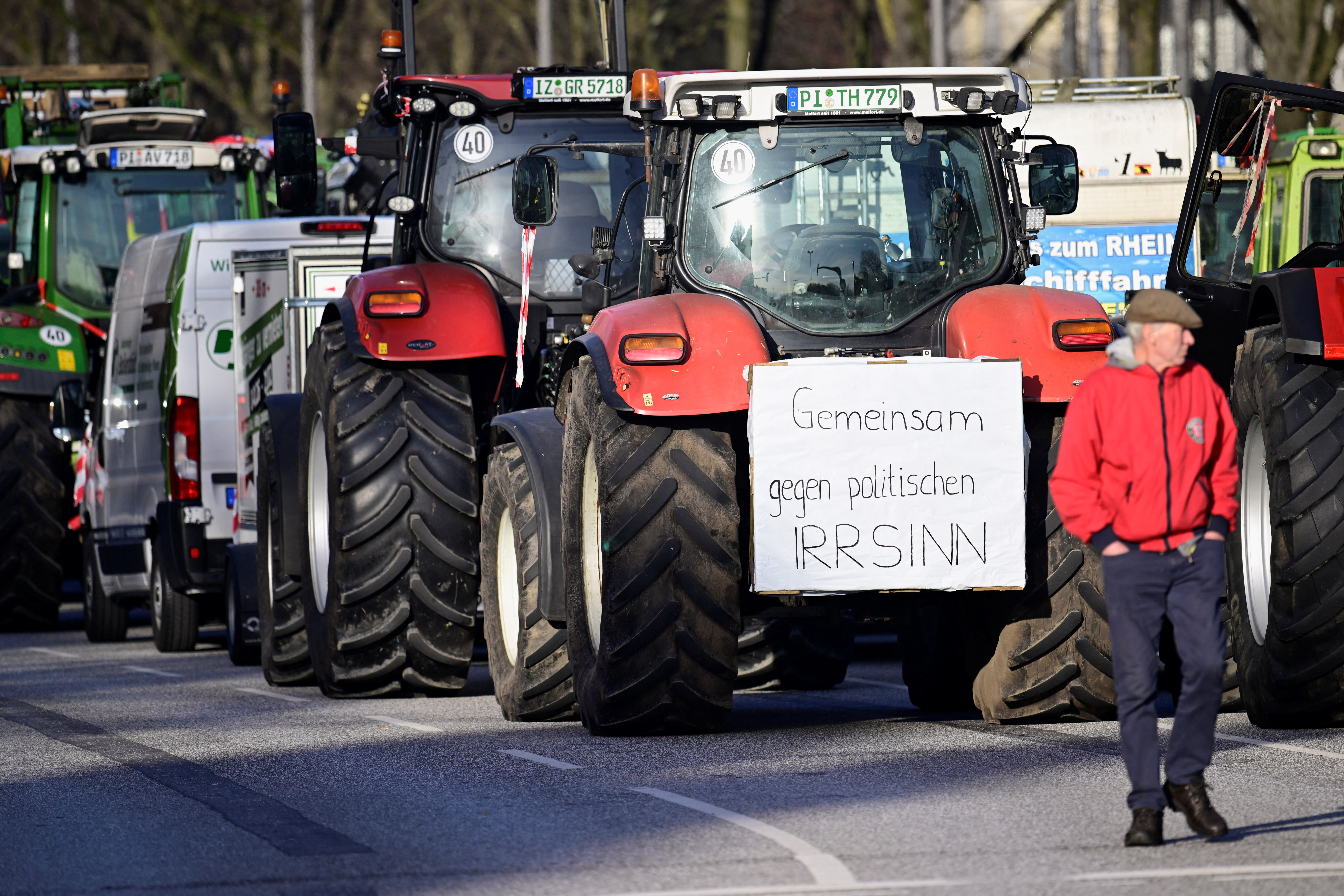 German farmers protest against the cut of farm vehicle tax subsidies of the so-called German Ampel coalition government, in Hamburg, Germany January 29, 2024. The banner reads "Together against political madness." REUTERS