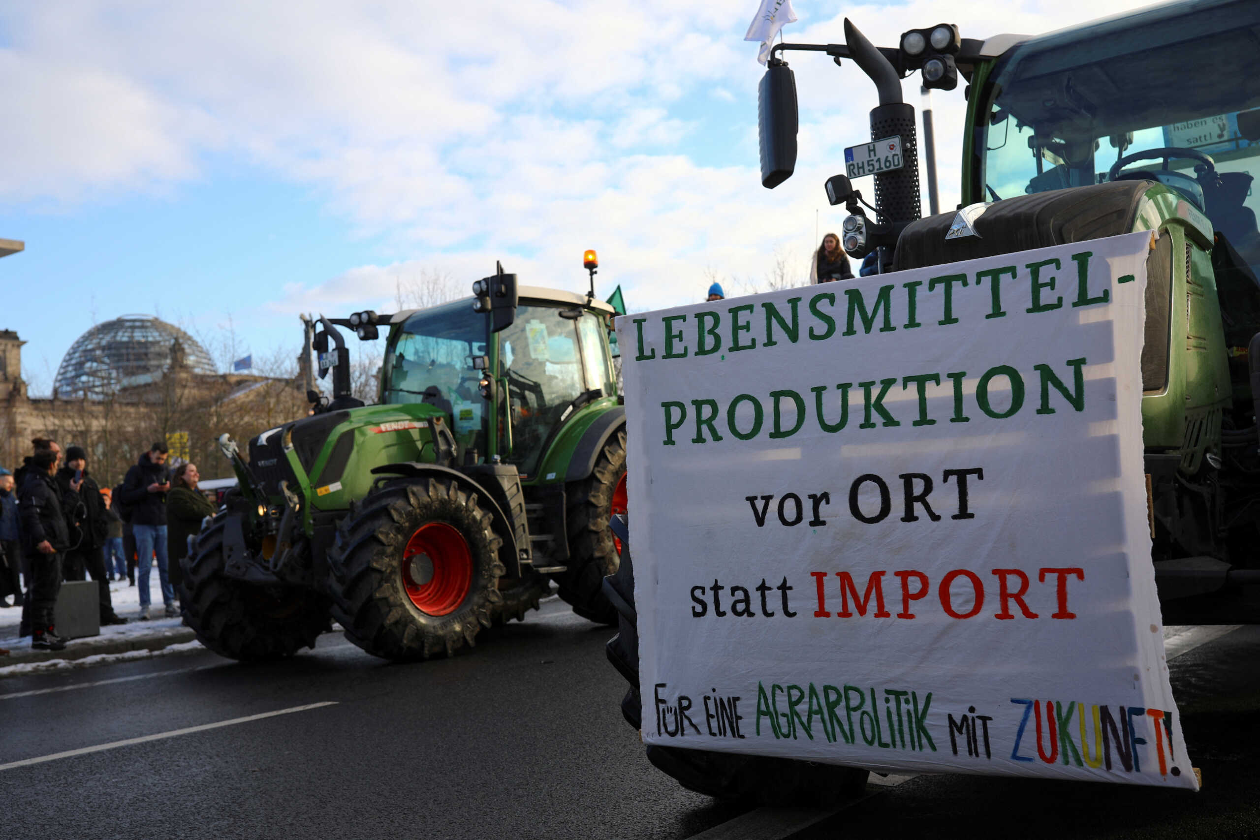 A banner is displayed on a tractor during a protest by German farmers, on the day of the 16th Global Forum for Food and Agriculture during Green Week agriculture fair, near the Reichstag building in Berlin, Germany January 20, 2024. REUTERS
