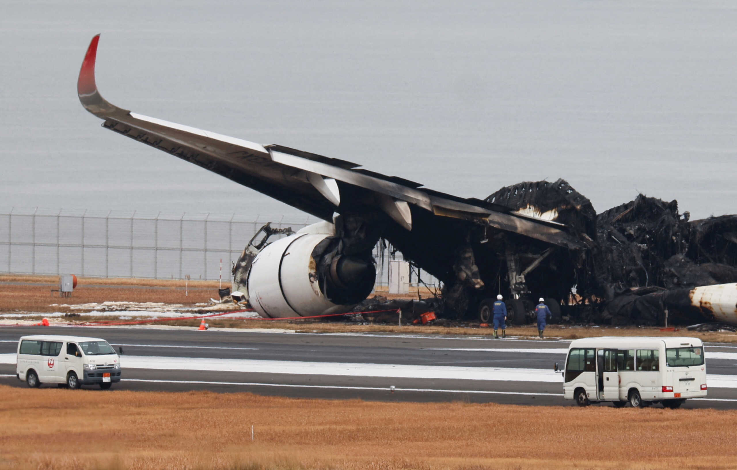 Officials investigate a burnt Japan Airlines (JAL) Airbus A350 plane after a collision with a Japan Coast Guard aircraft at Haneda International Airport in Tokyo, Japan January 3, 2024.  REUTERS