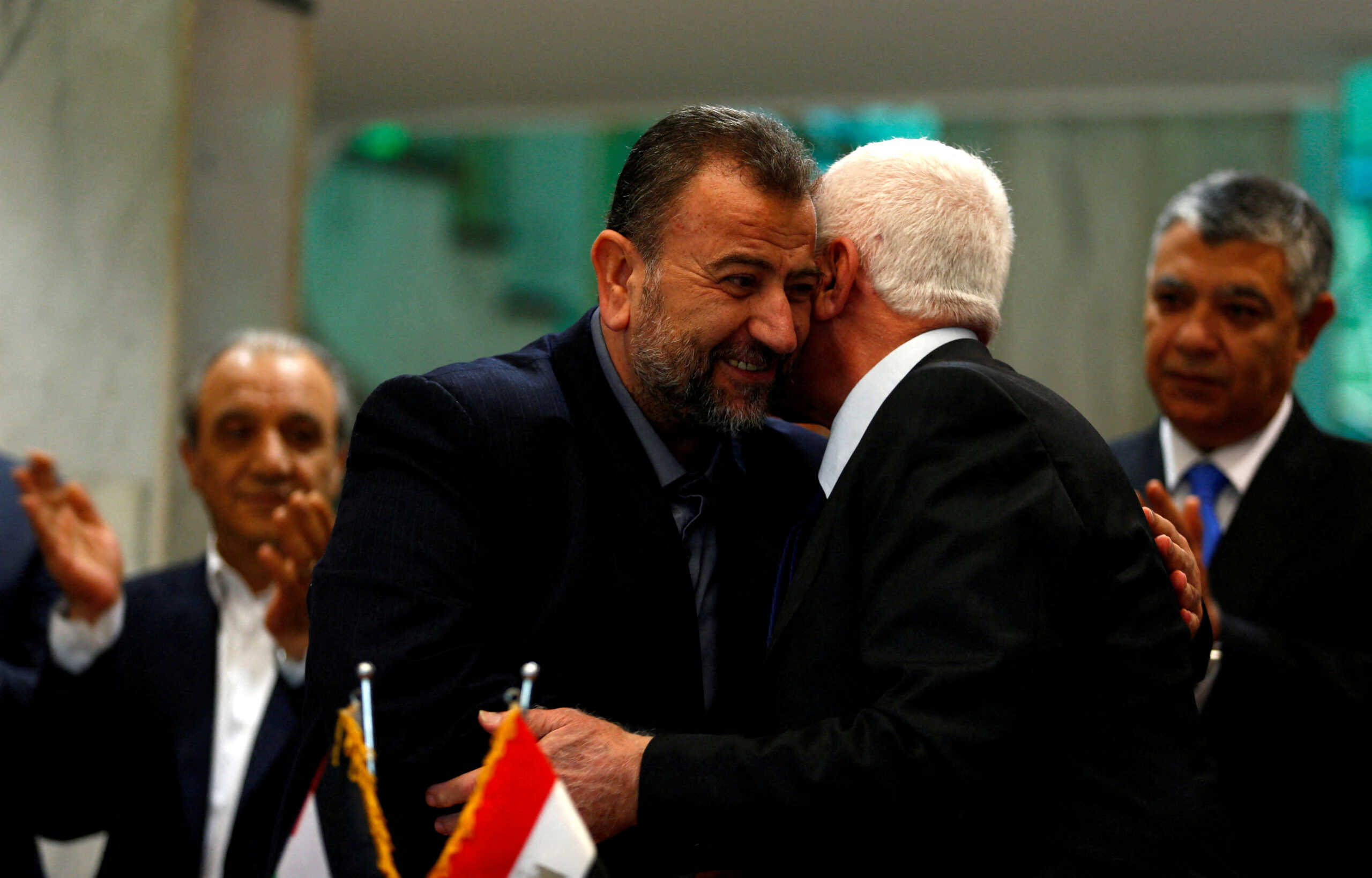 FILE PHOTO: Head of Hamas delegation Saleh al-Arouri hugs Fatah leader Azzam Ahmad as they sign a reconciliation deal in Cairo, Egypt, October 12, 2017. REUTERS