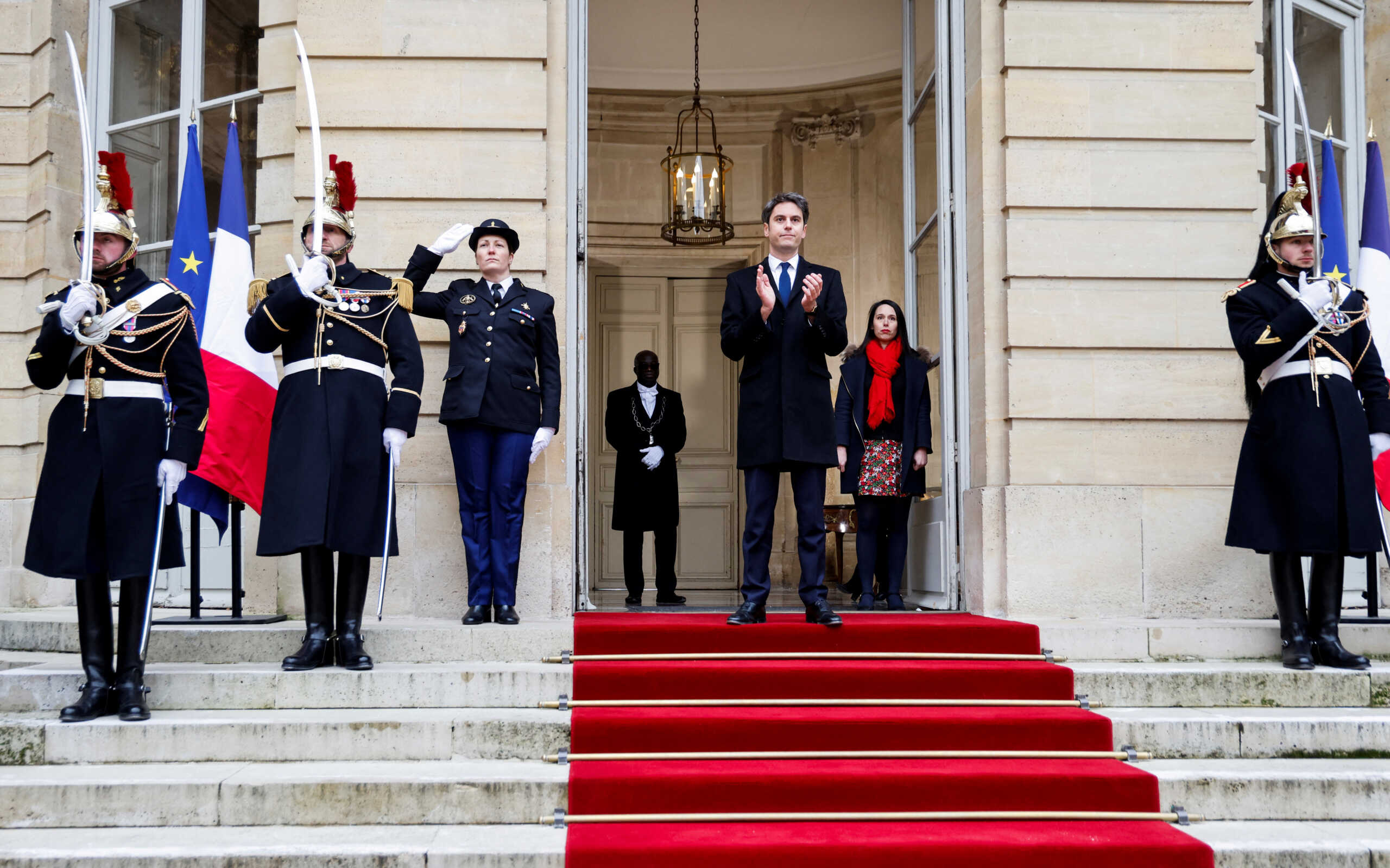 France's newly appointed Prime Minister Gabriel Attal applauds as outgoing Prime Minister Elisabeth Borne leaves at the end of the handover ceremony at the Hotel Matignon in Paris, France, on January 9, 2024. Ludovic Marin