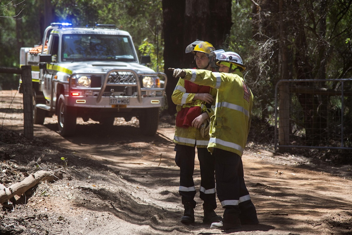 epa11040659 Firefighters at work after a bushfire when through the area at Parkerville in Perth, Western Australia (WA), Australia, 22 December 2023. Crews in WA have faced 'intense fire behavior' driven by strong and gusty winds and low humidity. WA Premier Roger Cook confirmed on the day that three homes have been destroyed in the blaze in Parkerville.  EPA