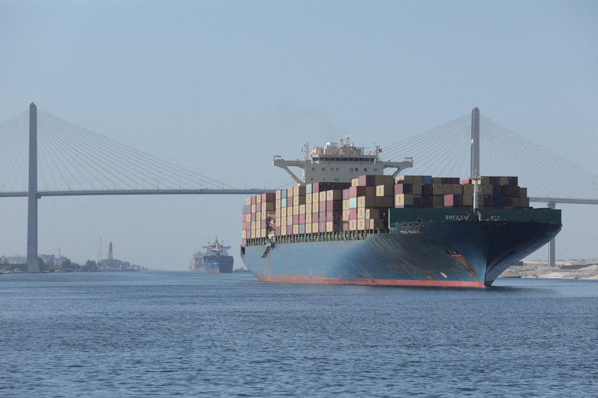 FILE PHOTO: A container ship is seen near Suez Canal Bridge which is known as the "Peace Bridge". Suez Canal Authority