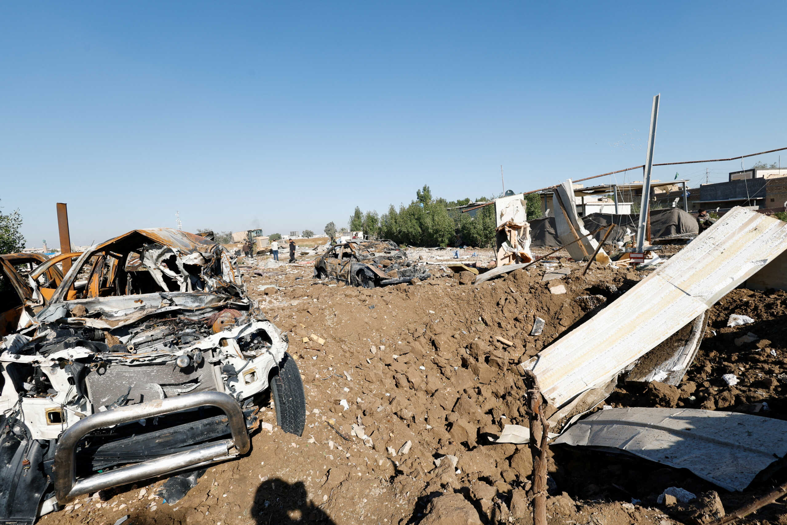 Debris lays near destroyed cars at the site of a U.S. airstrike, in Hilla, Iraq December 26, 2023. REUTERS