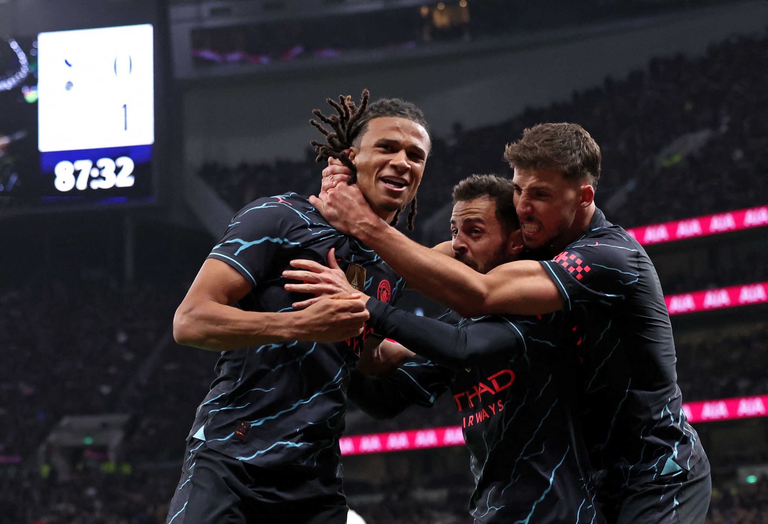 Soccer Football -  FA Cup - Fourth Round - Tottenham Hotspur v Manchester City - Tottenham Hotspur Stadium, London, Britain - January 26, 2024  Manchester City's Nathan Ake celebrates scoring their first goal with Bernardo Silva and Ruben Dias REUTERS