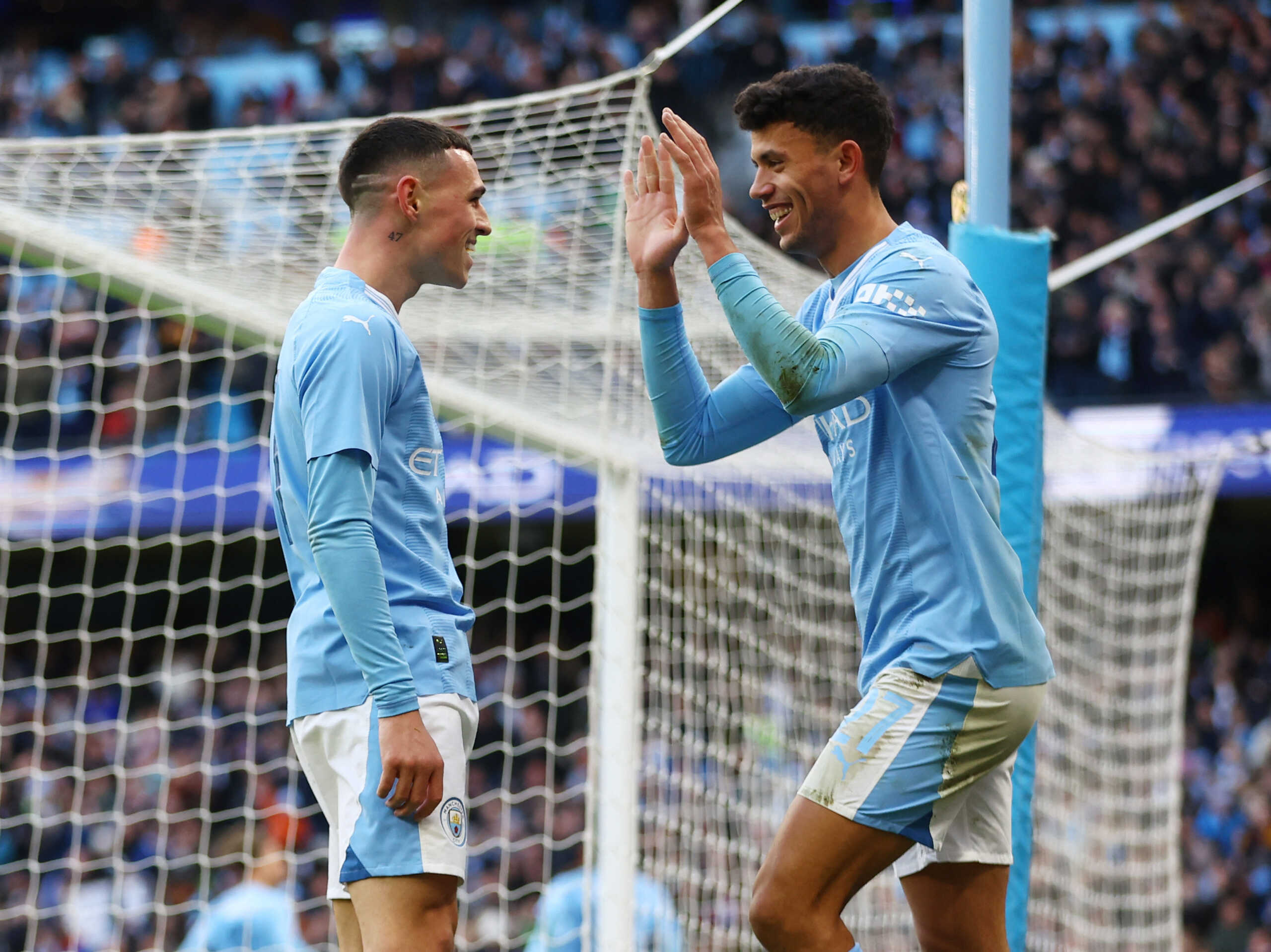 Soccer Football -  FA Cup - Third Round - Manchester City v Huddersfield Town - Etihad Stadium, Manchester, Britain - January 7, 2024 Manchester City's Matheus Nunes and Phil Foden celebrate their second goal, scored by Julian Alvarez REUTERS