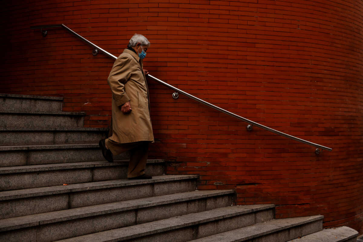 A man wearing a protective face mask leaves a health center in Madrid, Spain, January 10, 2024. REUTERS