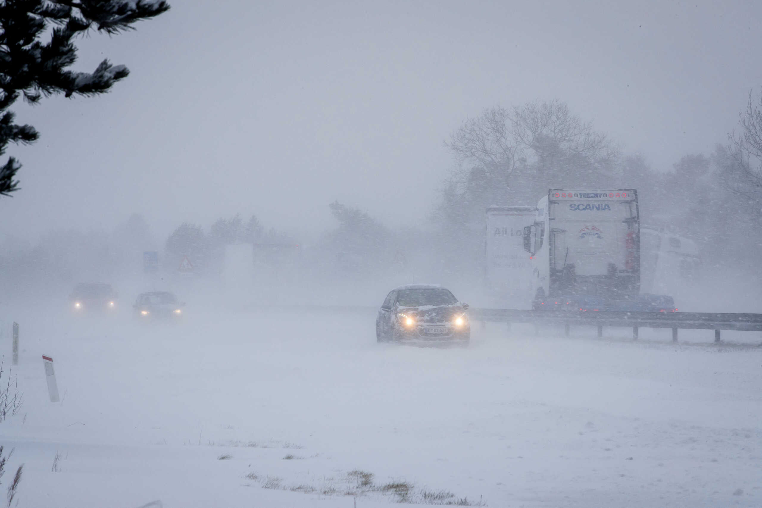 Vehicles drive amid snowfall in Viborg, Denmark January 3, 2024.  Johnny Pedersen