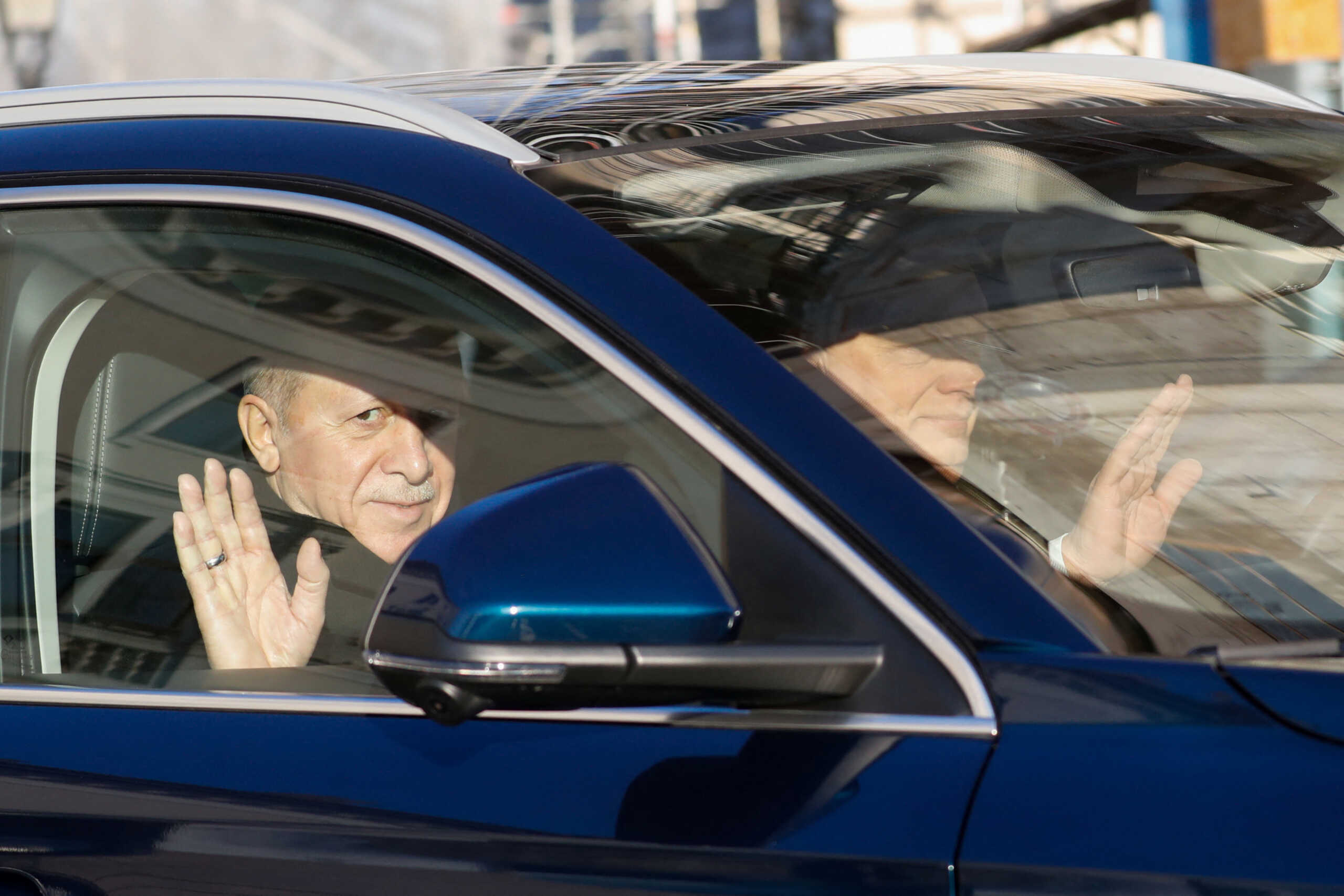 Hungarian Prime Minister Viktor Orban and Turkish President Recep Tayyip Erdogan wave as they drive a car in Budapest, Hungary, December 18, 2023. REUTERS