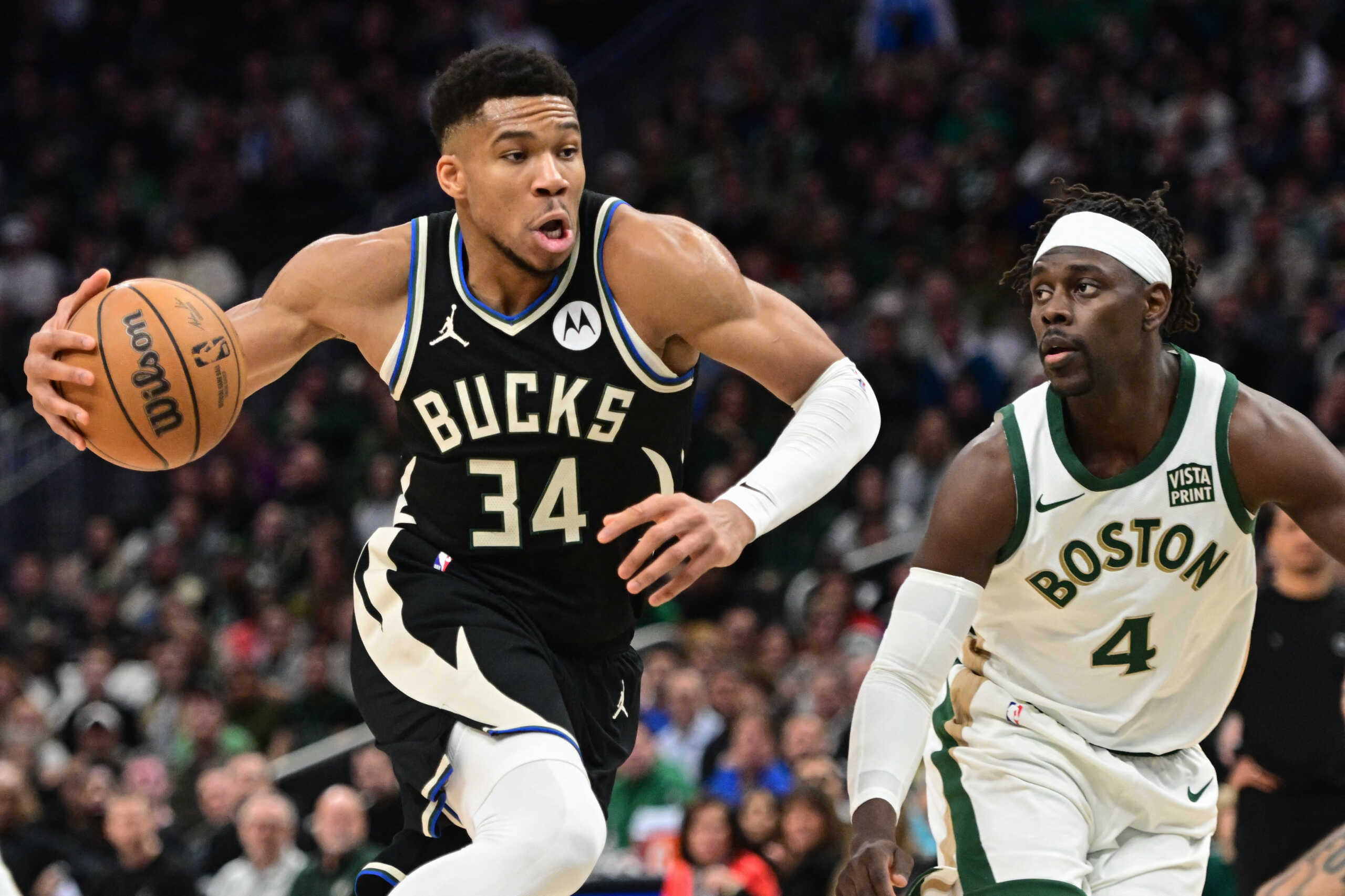Jan 11, 2024; Milwaukee, Wisconsin, USA;  Milwaukee Bucks forward Giannis Antetokounmpo (34) drives for the basket against Boston Celtics guard Jrue Holiday (4) in the second quarter at Fiserv Forum. Mandatory Credit: Benny Sieu-USA TODAY Sports