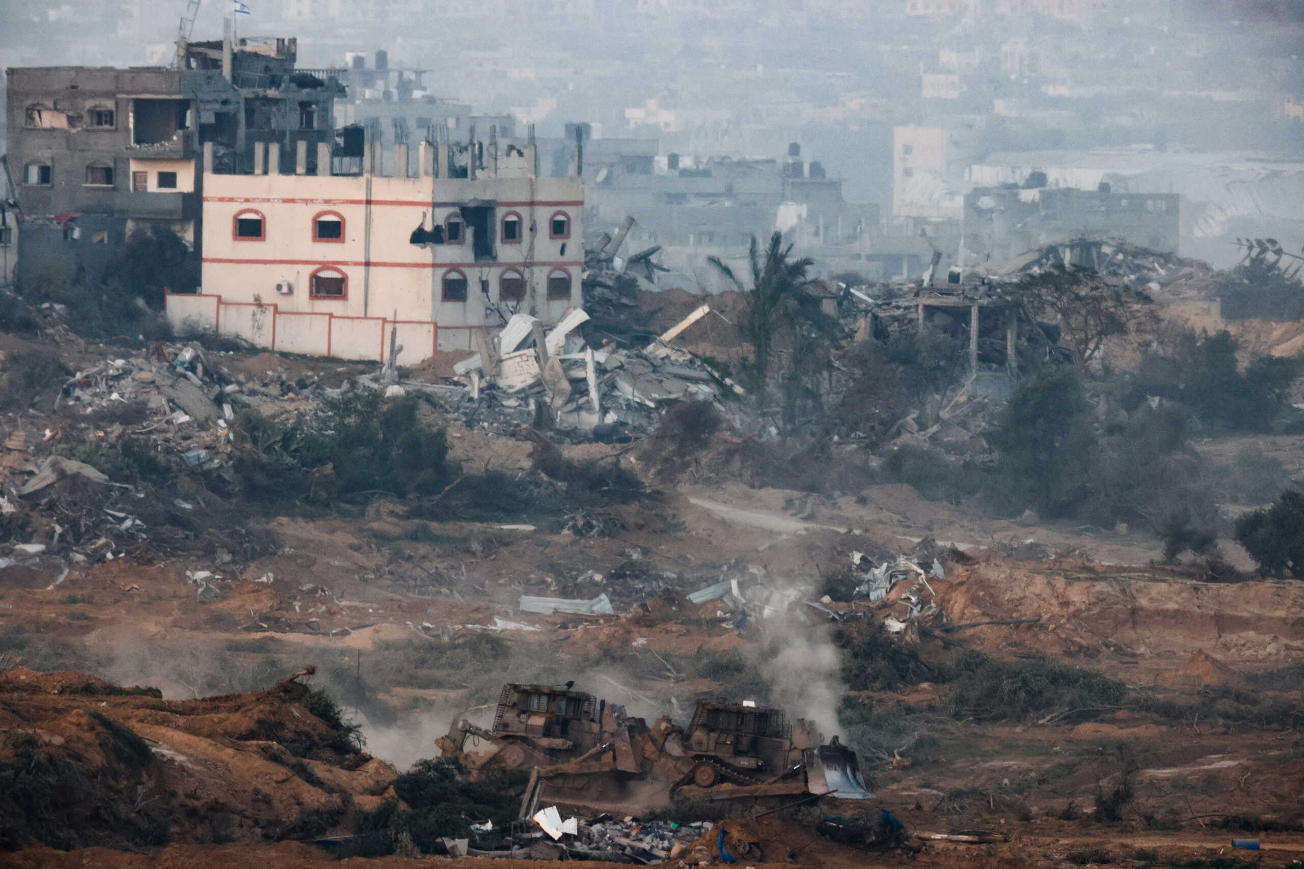 D9 bulldozers manoeuvre in central Gaza, amid the ongoing conflict between Israel and the Palestinian Islamist group Hamas, as seen from Israel's border with Gaza in southern Israel, January 9, 2024. REUTERS