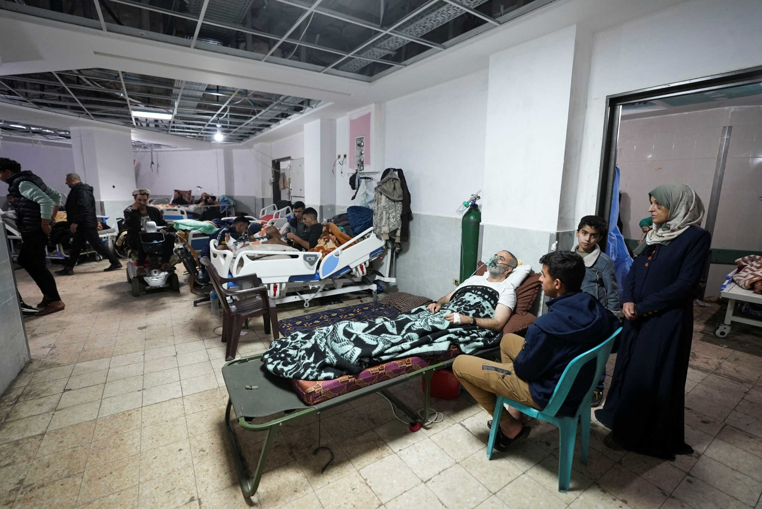 Palestinians wounded in Israeli strikes lie on beds as displaced people shelter at Shuhada Al-Aqsa Hospital, amid the ongoing conflict between Israel and Hamas, in Deir Al-Balah in the central Gaza Strip, January 3, 2024. REUTERS