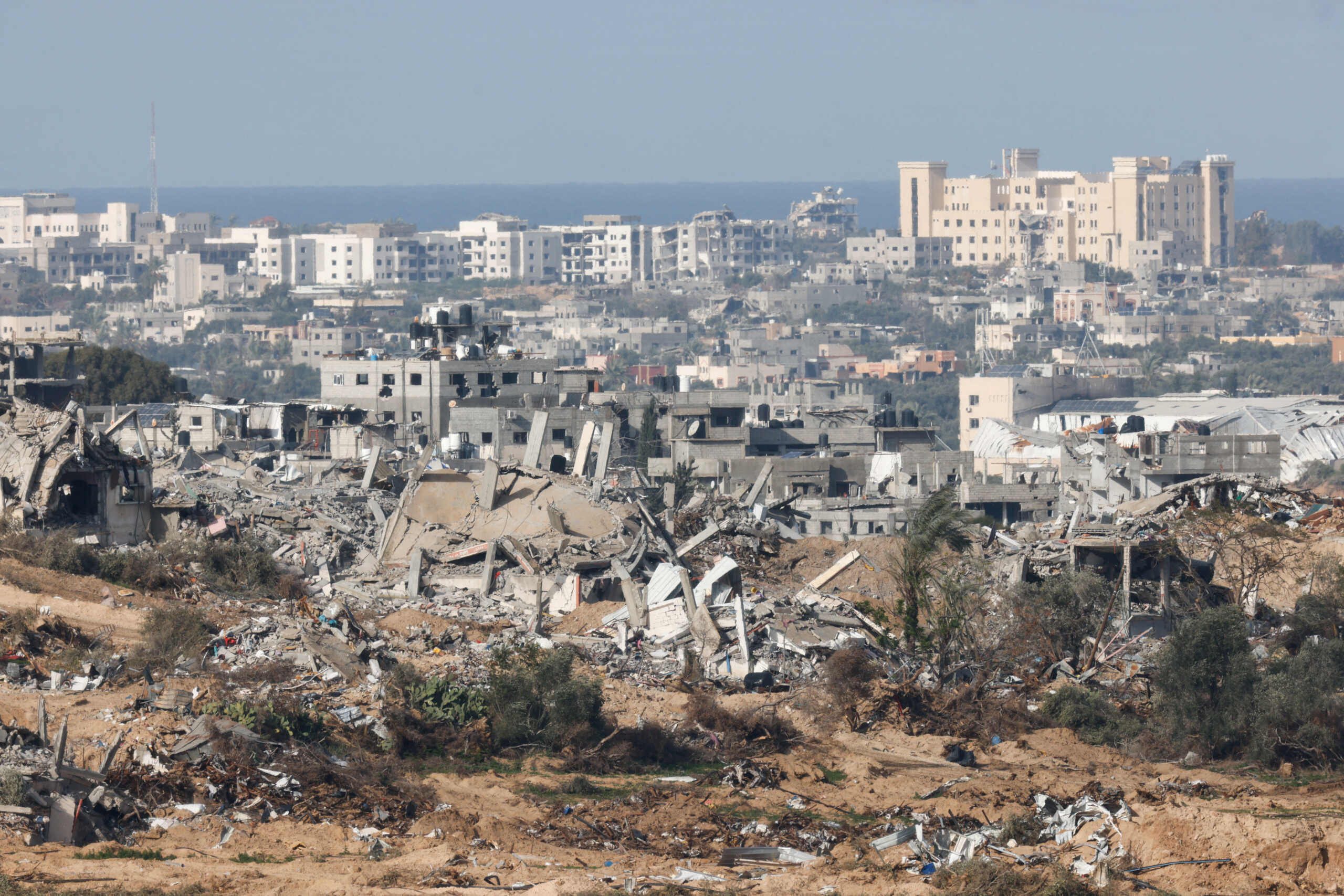 Destroyed buildings lie in ruin in central Gaza, amid the ongoing conflict between Israel and the Palestinian Islamist group Hamas, near the Israel-Gaza border, as seen from Israel, January 13, 2024. REUTERS
