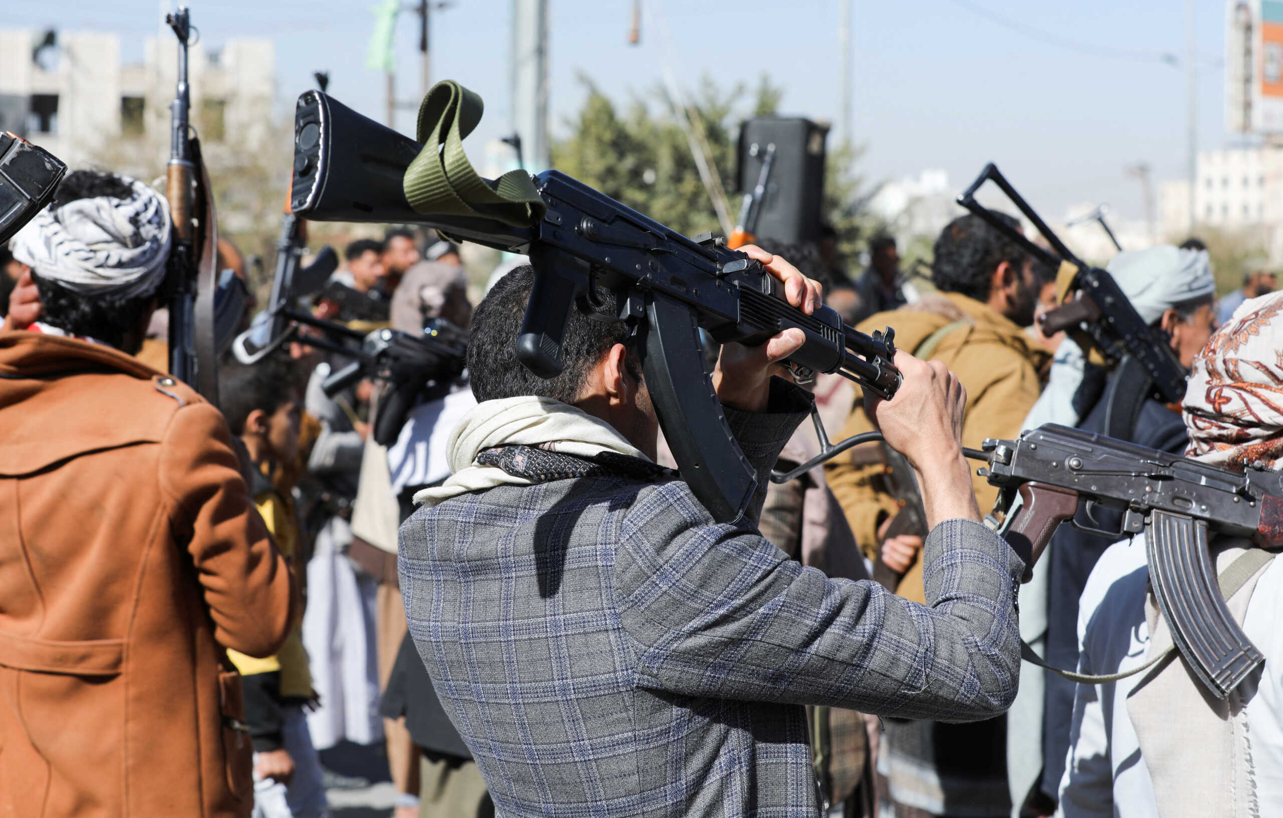 Newly recruited Houthi fighters hold up firearms during a ceremony at the end of their training in Sanaa, Yemen January 11, 2024. REUTERS