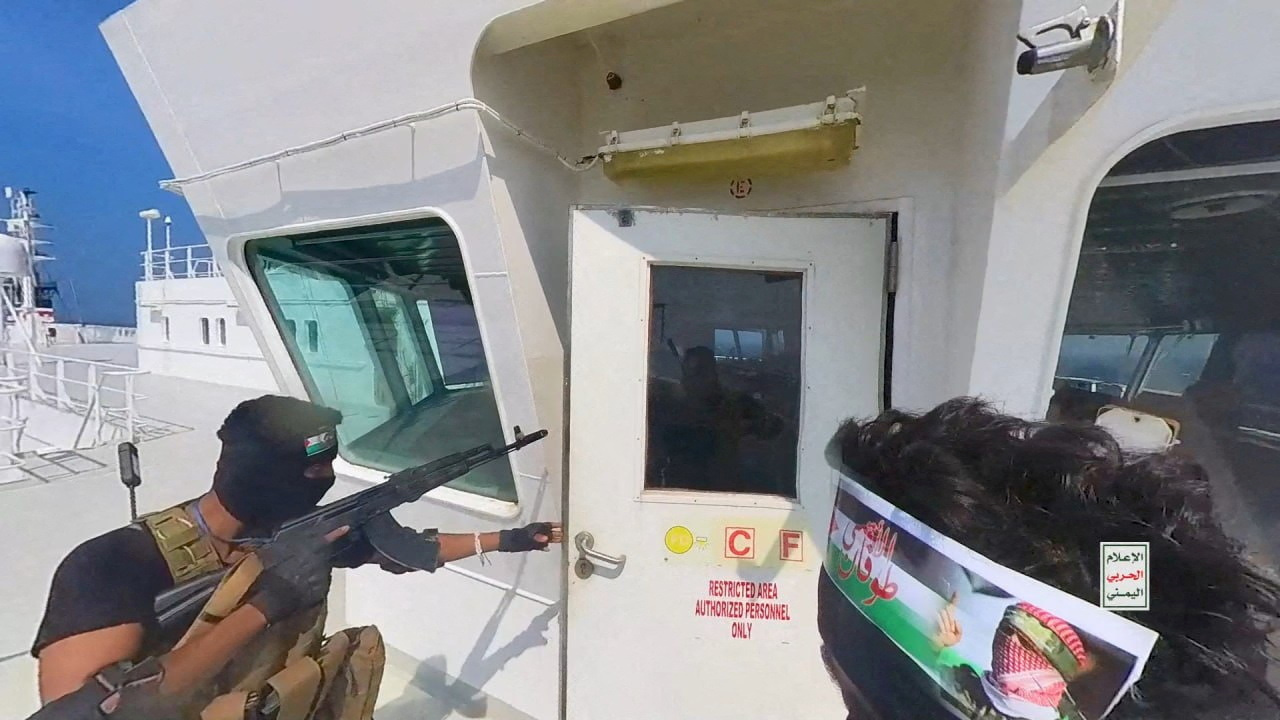 FILE PHOTO: FILE PHOTO: Houthi fighters open the door of the cockpit on the ship's deck in the Red Sea in this photo released November 20, 2023. Houthi Military Media