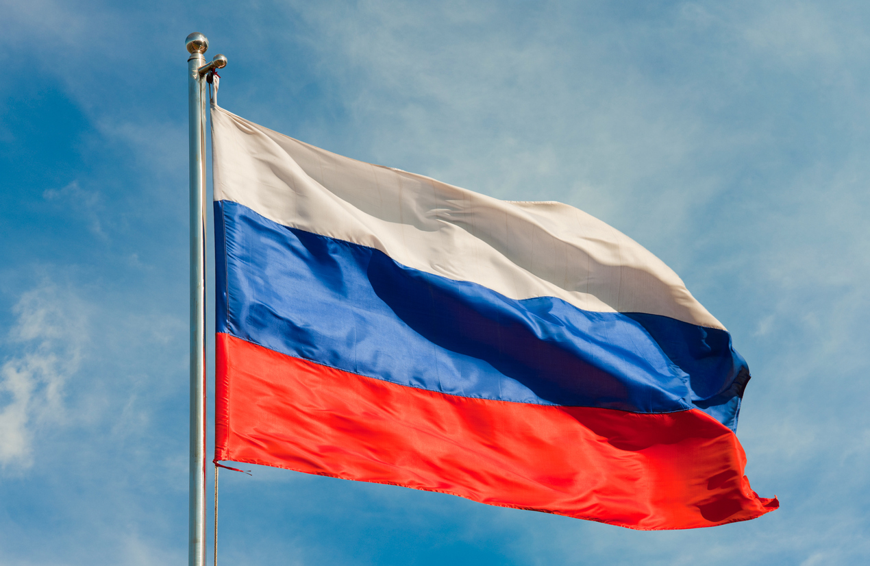 russian flag on a pole over beautiful sky