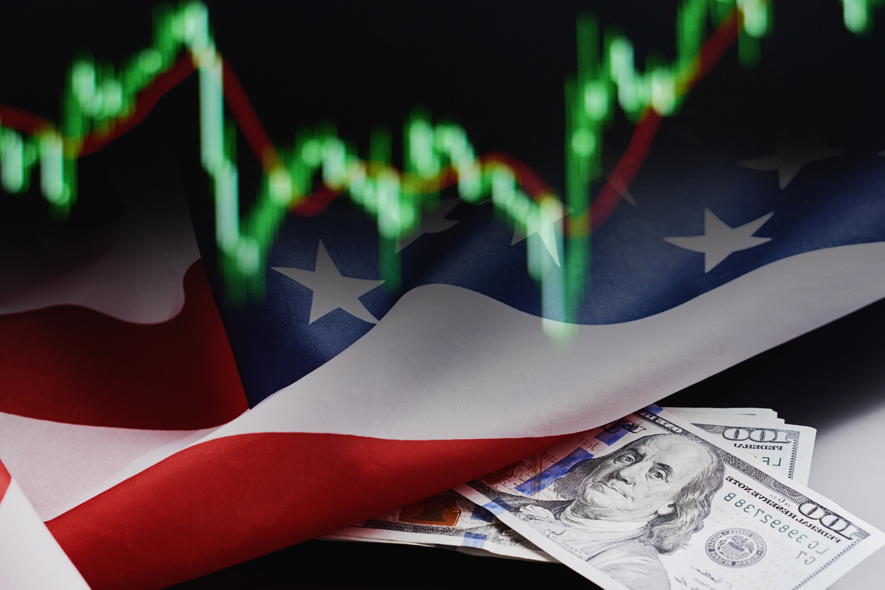 Financial crisis in the global economy concept. Stock market currency quotes, american flag and dollar bills on a dark background