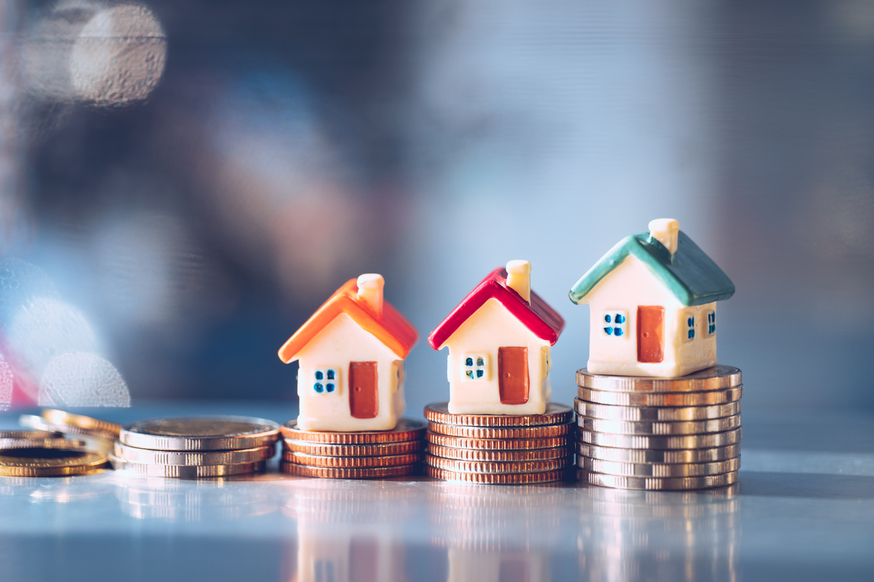 Miniature colorful house on stack coins using as property real estate and financial concept