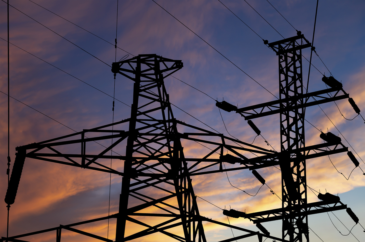 Electricity pylon (high voltage power line), black contour,  against the background of a romantic evening sky