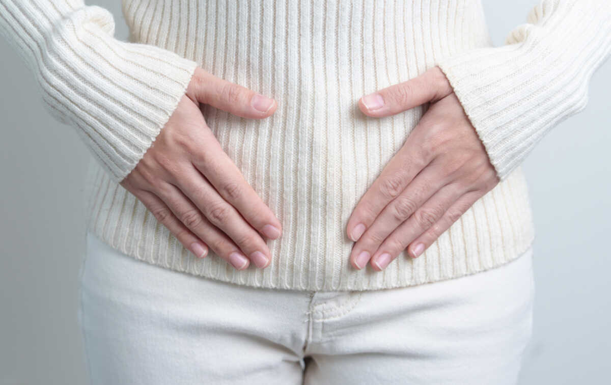 Woman holding  her belly. Pregnancy, Reproductive system, menstruation, and gynecology concept