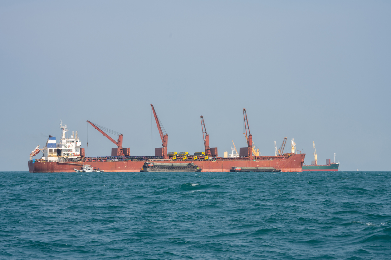 cargo ship in the ocean for export import goods from cargo yard port to customs ocean concept freight shipping by ship