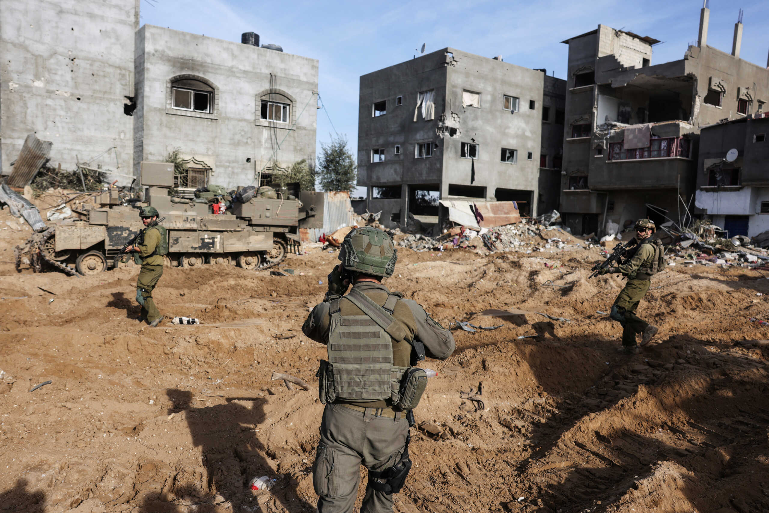 Israeli soldiers walk as they operate, amid the ongoing conflict between Israel and the Palestinian Islamist group Hamas, in Gaza, January 8, 2024. REUTERS
