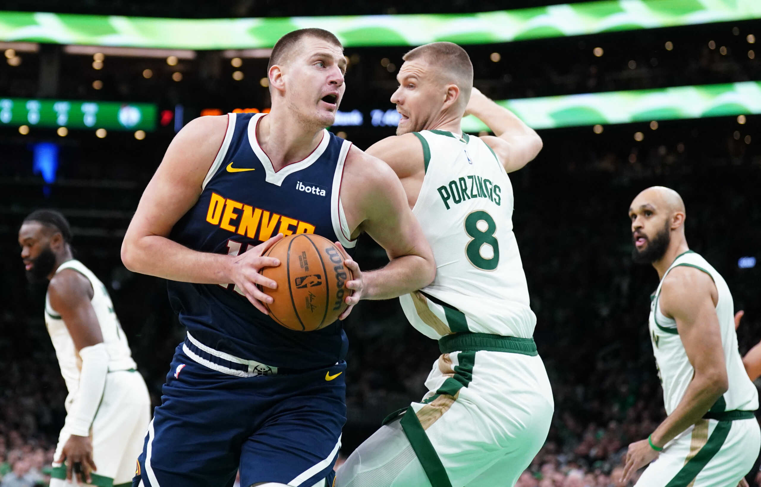 Jan 19, 2024; Boston, Massachusetts, USA; Denver Nuggets center Nikola Jokic (15) moves the ball against Boston Celtics center Kristaps Porzingis (8) in the first quarter at TD Garden. Mandatory Credit: David Butler II-USA TODAY Sports