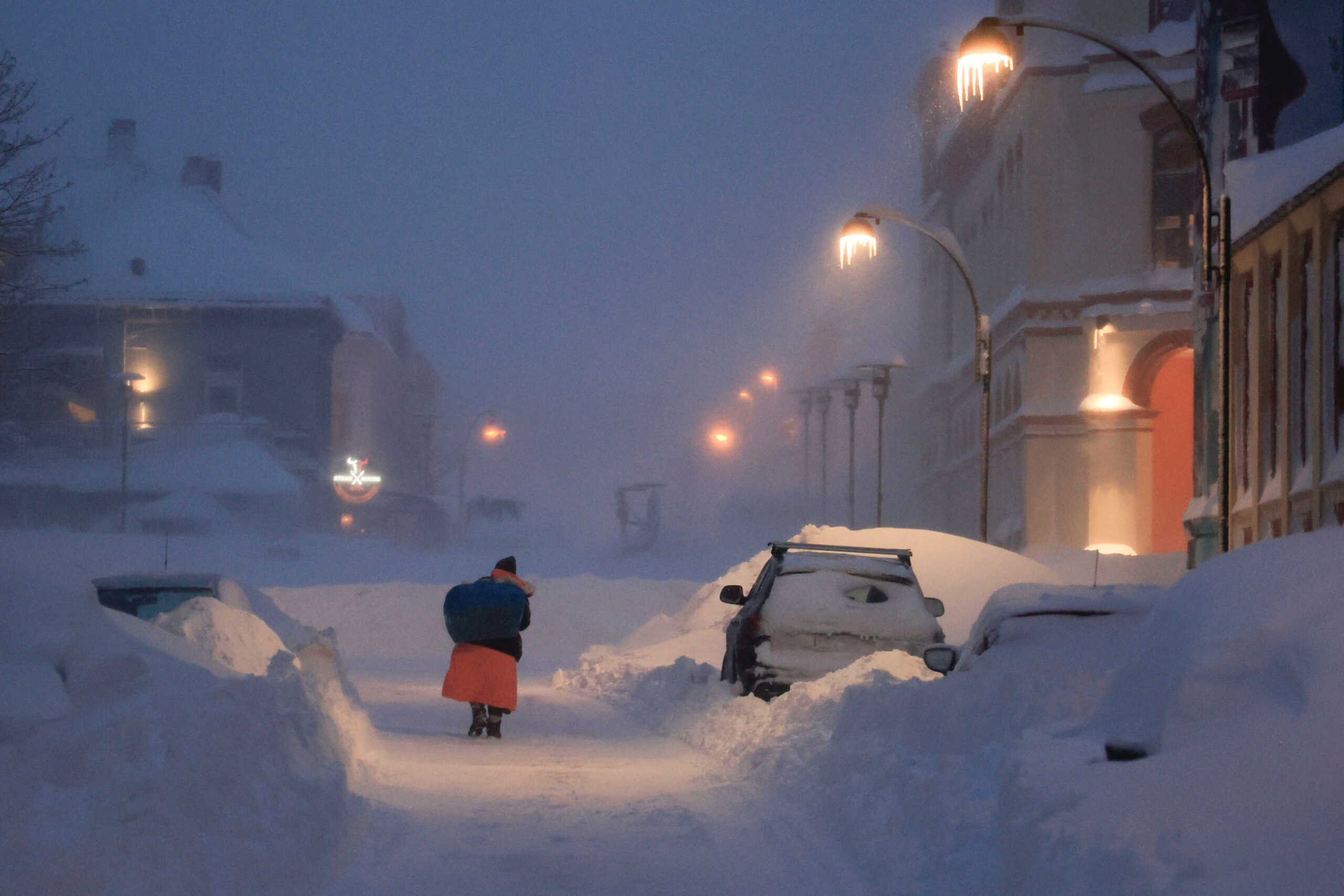 A person walks in a snowstorm in Kristiansand, Norway January 3, 2024. Tor Erik Schroder