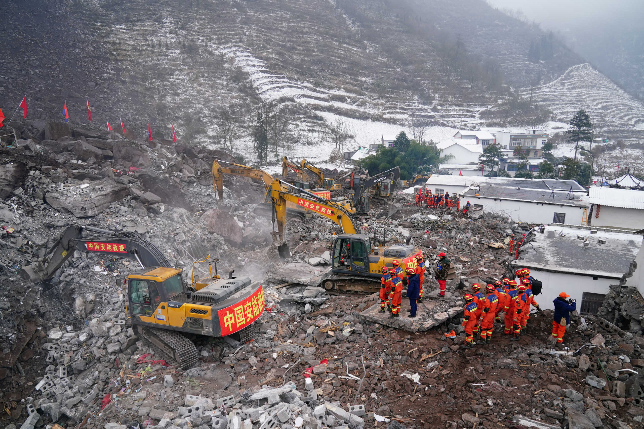 Rescue workers search for survivors in the debris after a landslide hit Liangshui village in Zhenxiong county of Zhaotong, Yunnan province, China January 23, 2024.  cnsphoto via REUTERS   ATTENTION EDITORS - THIS IMAGE WAS PROVIDED BY A THIRD PARTY. CHINA OUT.