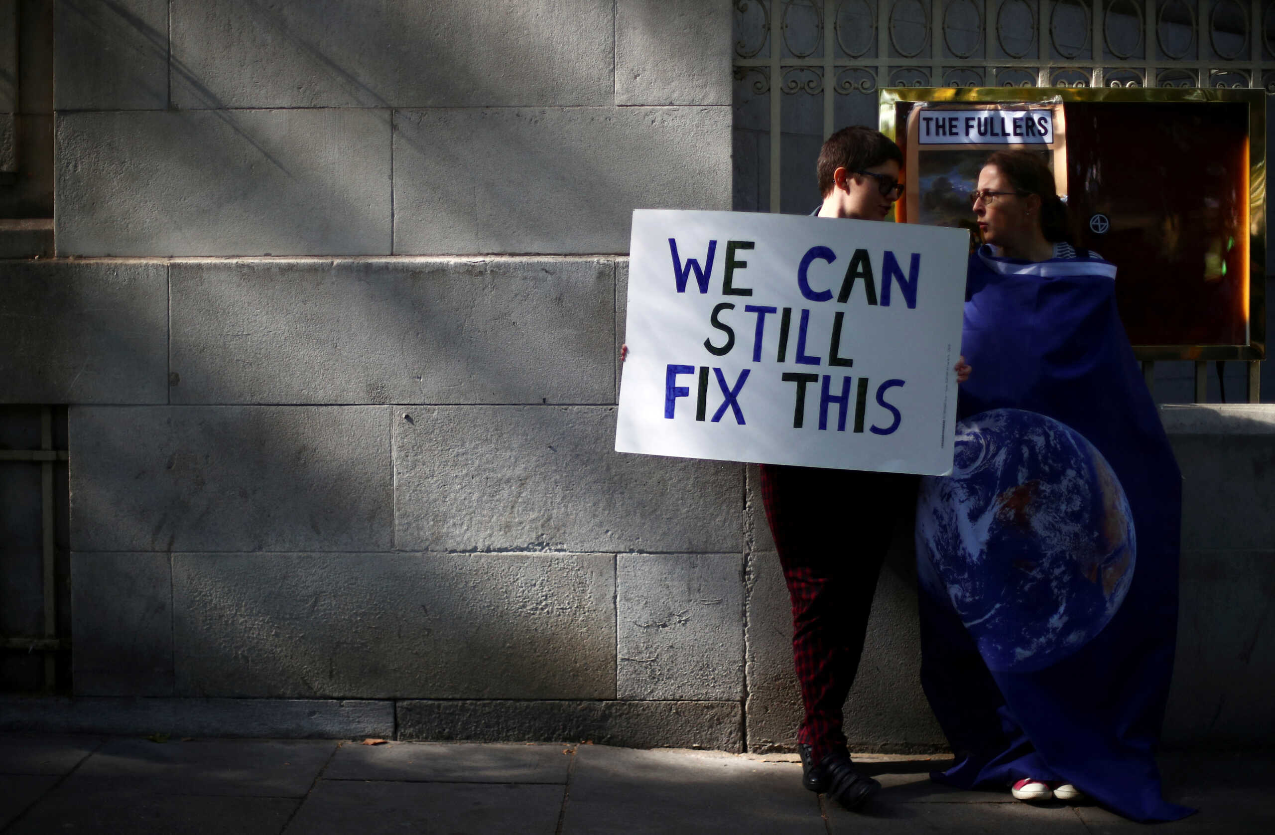 FILE PHOTO: FILE PHOTO: People attend a climate change demonstration in London, Britain, September 20, 2019. REUTERS