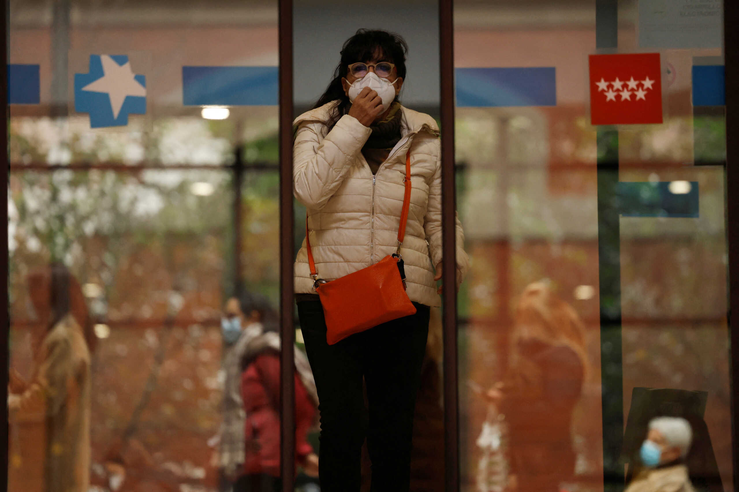 A woman wearing a protective face mask leaves a health center in Madrid, Spain, January 10, 2024. REUTERS