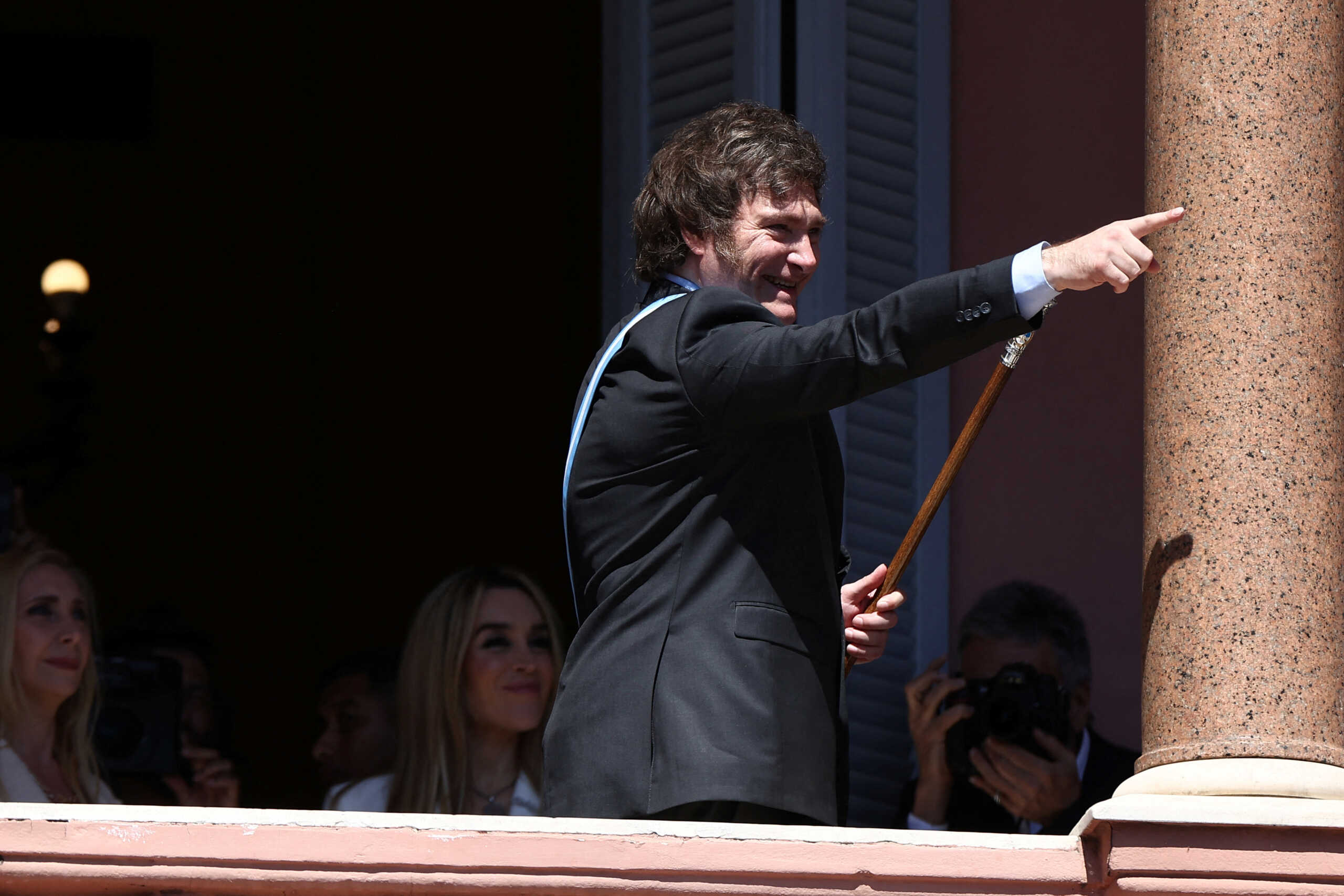 Argentina's President Javier Milei gestures to supporters from the Casa Rosada balcony, as his sister Karina Milei and his partner Fatima Florez look on, after his swearing-in ceremony, in Buenos Aires, Argentina December 10, 2023. REUTERS