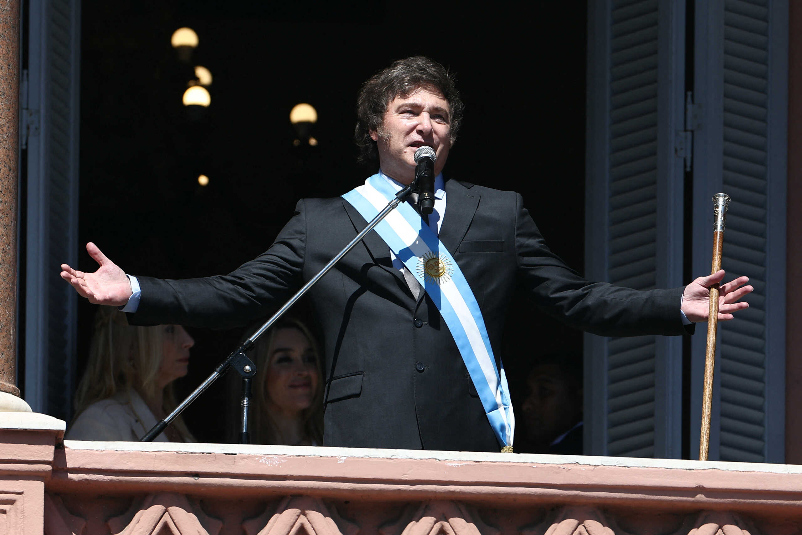 Argentina's President Javier Milei addresses supporters from the Casa Rosada balcony, as his sister Karina Milei and his partner Fatima Florez look on, after his swearing-in ceremony, in Buenos Aires, Argentina December 10, 2023. REUTERS