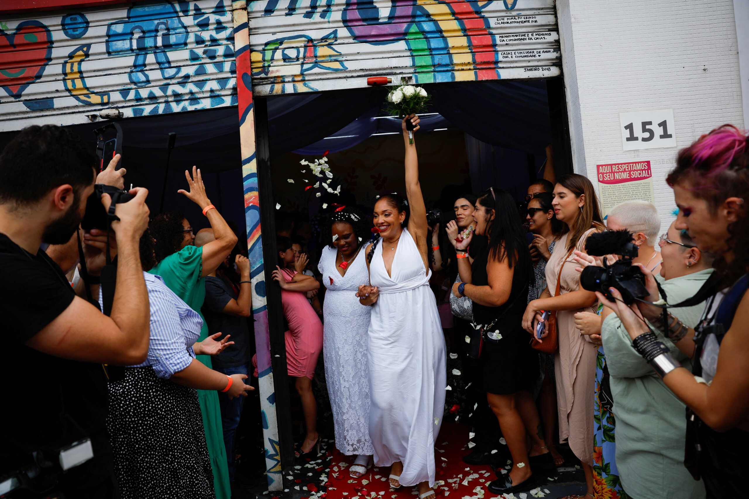 Brides Elaine Costa and Elida Nunes walk out after a collective wedding ceremony for 9 same-sex couples organized by "House 1", an NGO and residential shelter in Sao Paulo, Brazil December 16, 2023. REUTERS