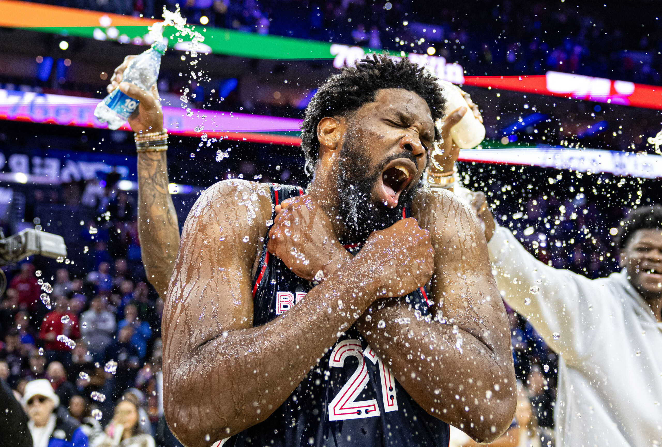 Jan 22, 2024; Philadelphia, Pennsylvania, USA; Philadelphia 76ers center Joel Embiid (21) is doused with water by teammates after scoring 70 points in a victory against the San Antonio Spurs at Wells Fargo Center. Mandatory Credit: Bill Streicher-USA TODAY Sports