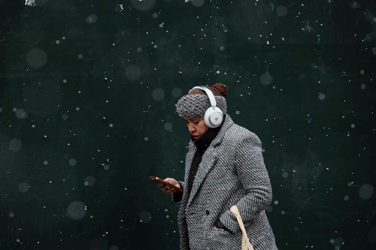 A woman walks during a brief snow fall in New York City, U.S., December 7, 2023.  REUTERS