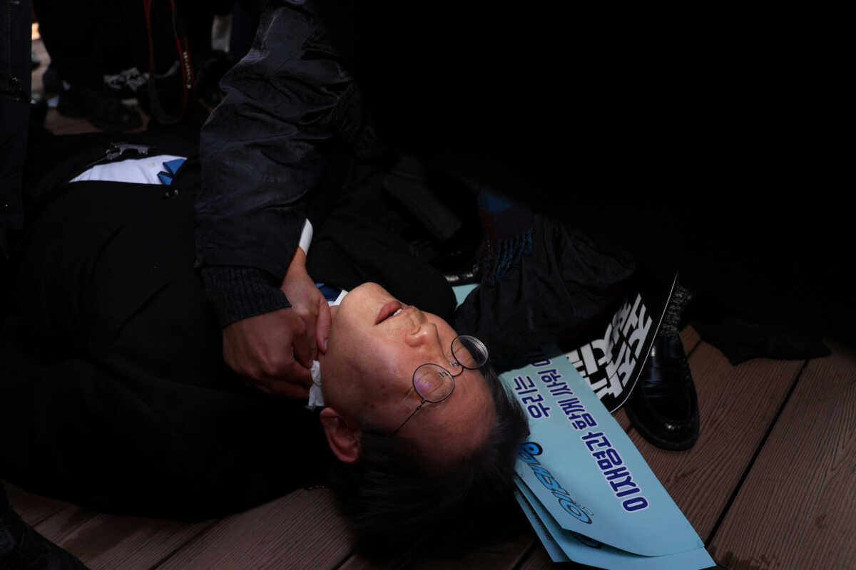 South Korea's opposition Democratic Party leader Lee Jae-myung falls after being attacked by an unidentified man during his visit to Busan, South Korea, January 1, 2024.    Yonhap via REUTERS   THIS IMAGE HAS BEEN SUPPLIED BY A THIRD PARTY. NO RESALES. NO ARCHIVES. SOUTH KOREA OUT. NO COMMERCIAL OR EDITORIAL SALES IN SOUTH KOREA.