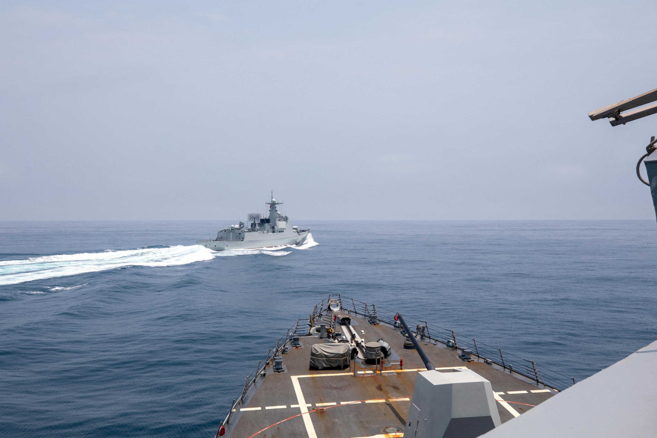FILE PHOTO: Chinese warship Luyang III sails near the U.S. destroyer USS Chung-Hoon, as seen from the deck of U.S. destroyer, in the Taiwan Strait, June 3, 2023, in this handout picture. U.S. Navy