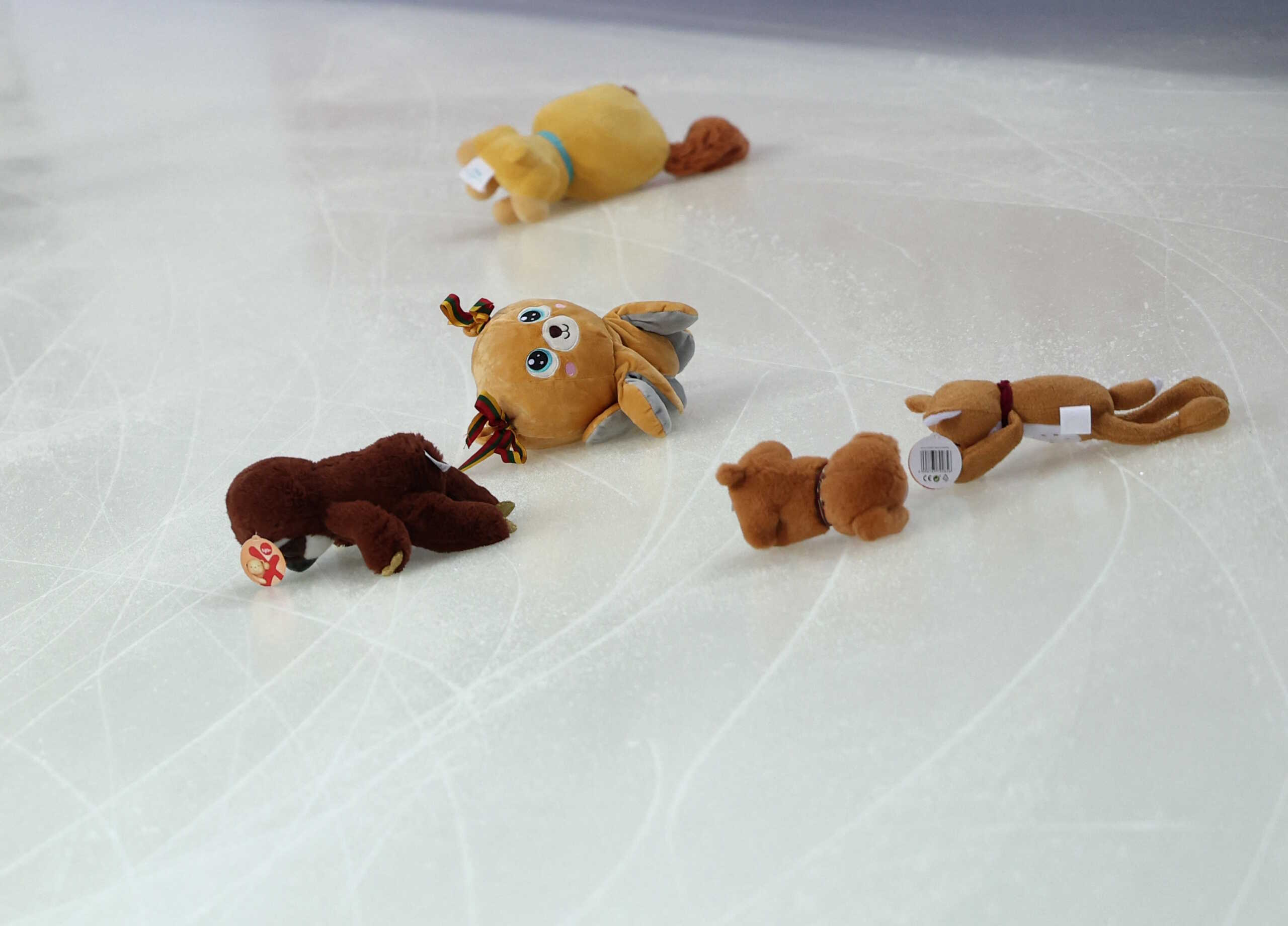 Figure Skating - European Figure Skating Championships - Zalgiris Arena, Kaunas, Lithuania - January 13, 2024 General view as a child is seen gathering teddy bears on the ice after Lithuania's Paulina Ramanskaite and Deividas Kizala perform during the free dance REUTERS