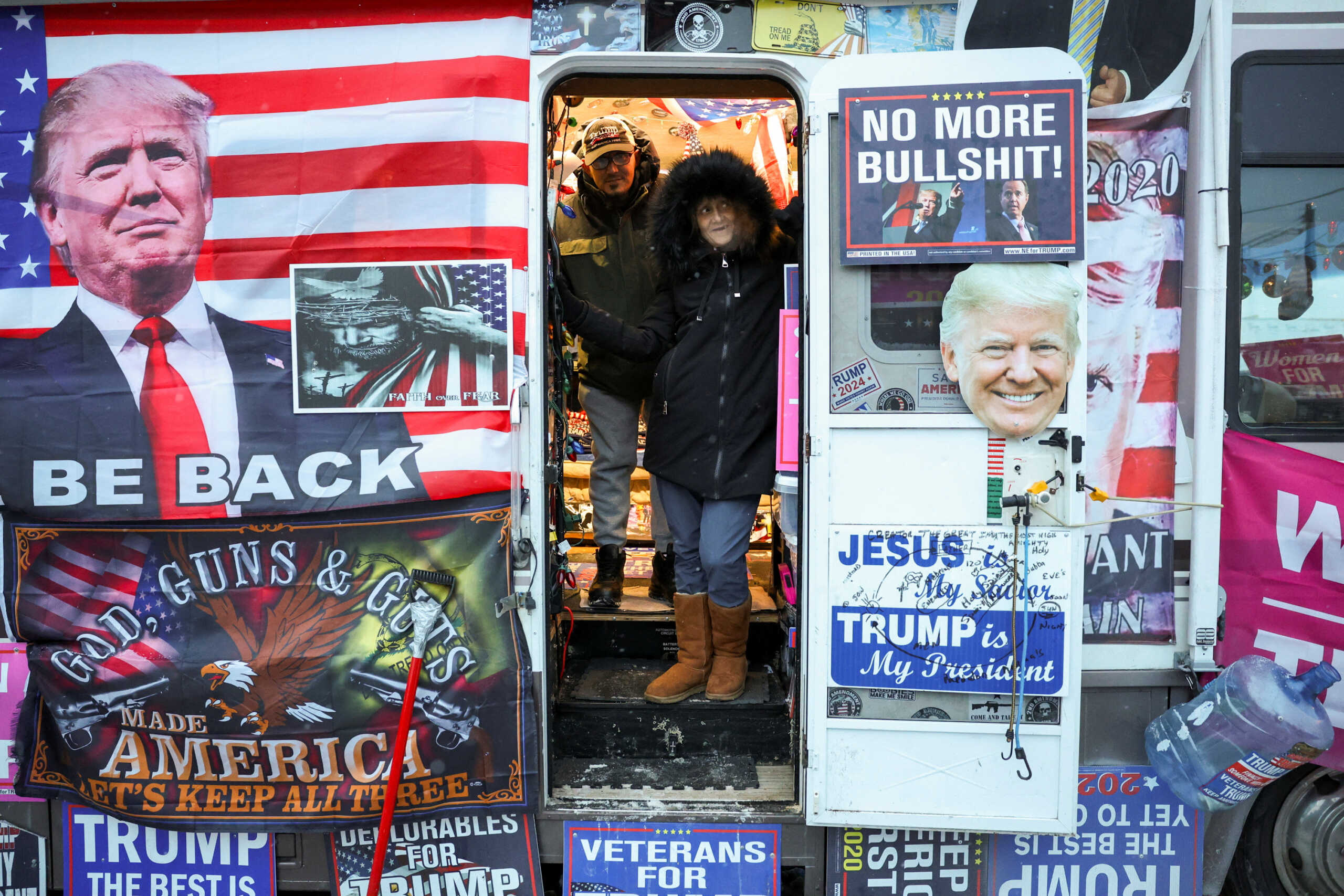 Donna Eiden and her son Michael Gonzalez watch the crowd from their RV before a rally by Republican presidential candidate and former U.S. President Donald Trump, ahead of the New Hampshire presidential primary election in Manchester, New Hampshire, U.S. January 20, 2024. Eiden has lived in "The Trump RV" for over 6 years and has traveled in it to over 100 Trump rallies. REUTERS