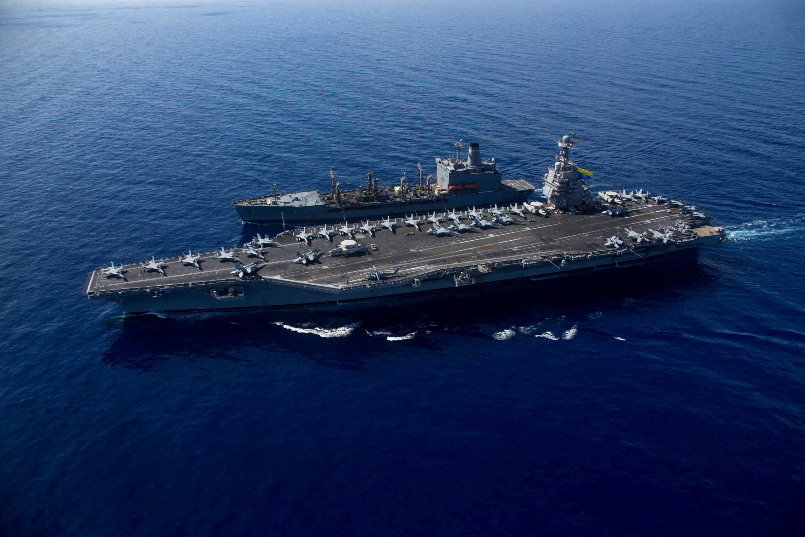 FILE PHOTO: The world's largest aircraft carrier USS Gerald R. Ford steams alongside USNS Laramie (T-AO-203) during a fueling-at-sea in the eastern Mediterranean Sea, as a scheduled deployment in the U.S Naval Forces Europe area of operations, deployed by U.S. Sixth Fleet to defend U.S, allied, and partners interests, in this photo taken on October, 11, 2023 and released by U.S. Navy on October 14, 2023. U.S Naval Forces Central Command
