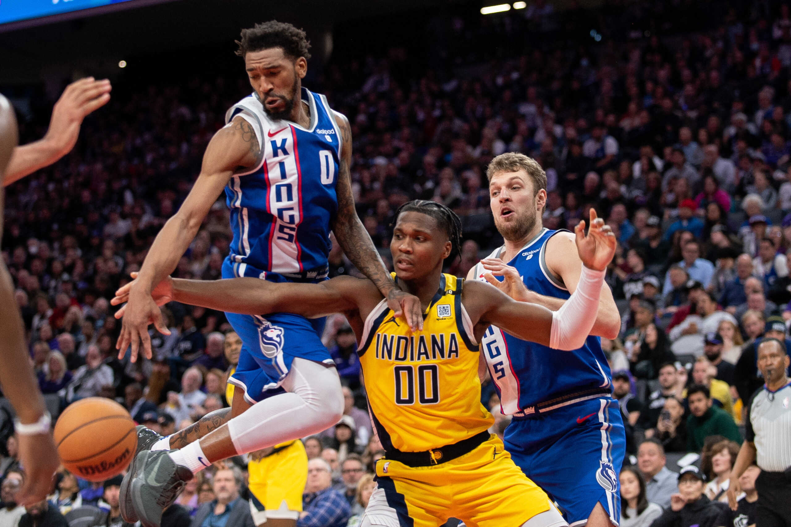 Jan 18, 2024; Sacramento, California, USA; Sacramento Kings guard Malik Monk (0) and Indiana Pacers guard Bennedict Mathurin (00) fight for possession of the ball during the fourth quarter at Golden 1 Center. Mandatory Credit: Ed Szczepanski-USA TODAY Sports