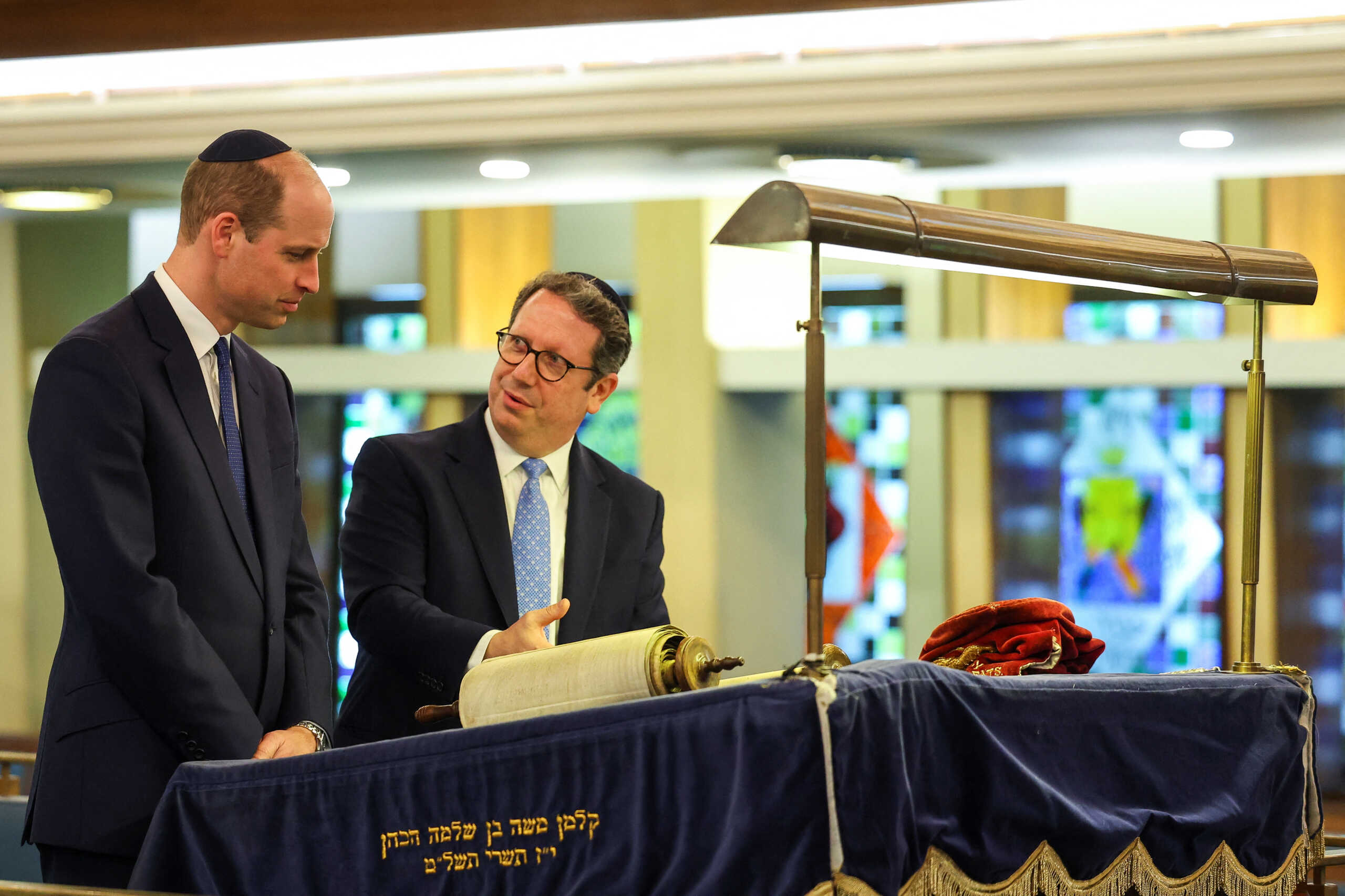 Rabbi Daniel Epstein shows Britain's Prince William a 17th century Torah scroll as he visits the Western Marble Arch Synagogue, in London, Britain, February 29, 2024. REUTERS